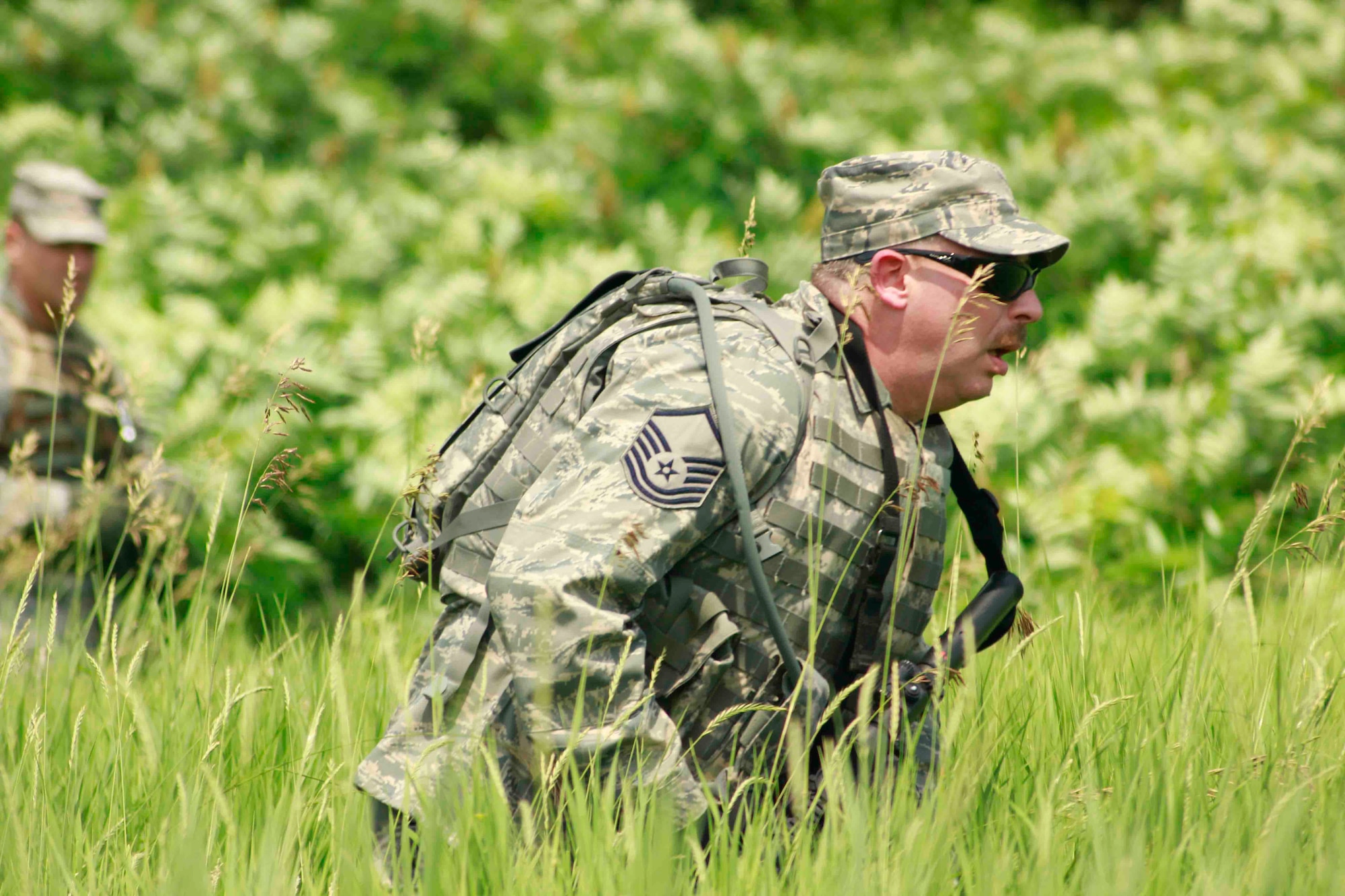 Master Sgt. Carl Herrmann stealthily traverses an open field. (Air Force Photo/Master Sgt. Nicollette Shegstad)

