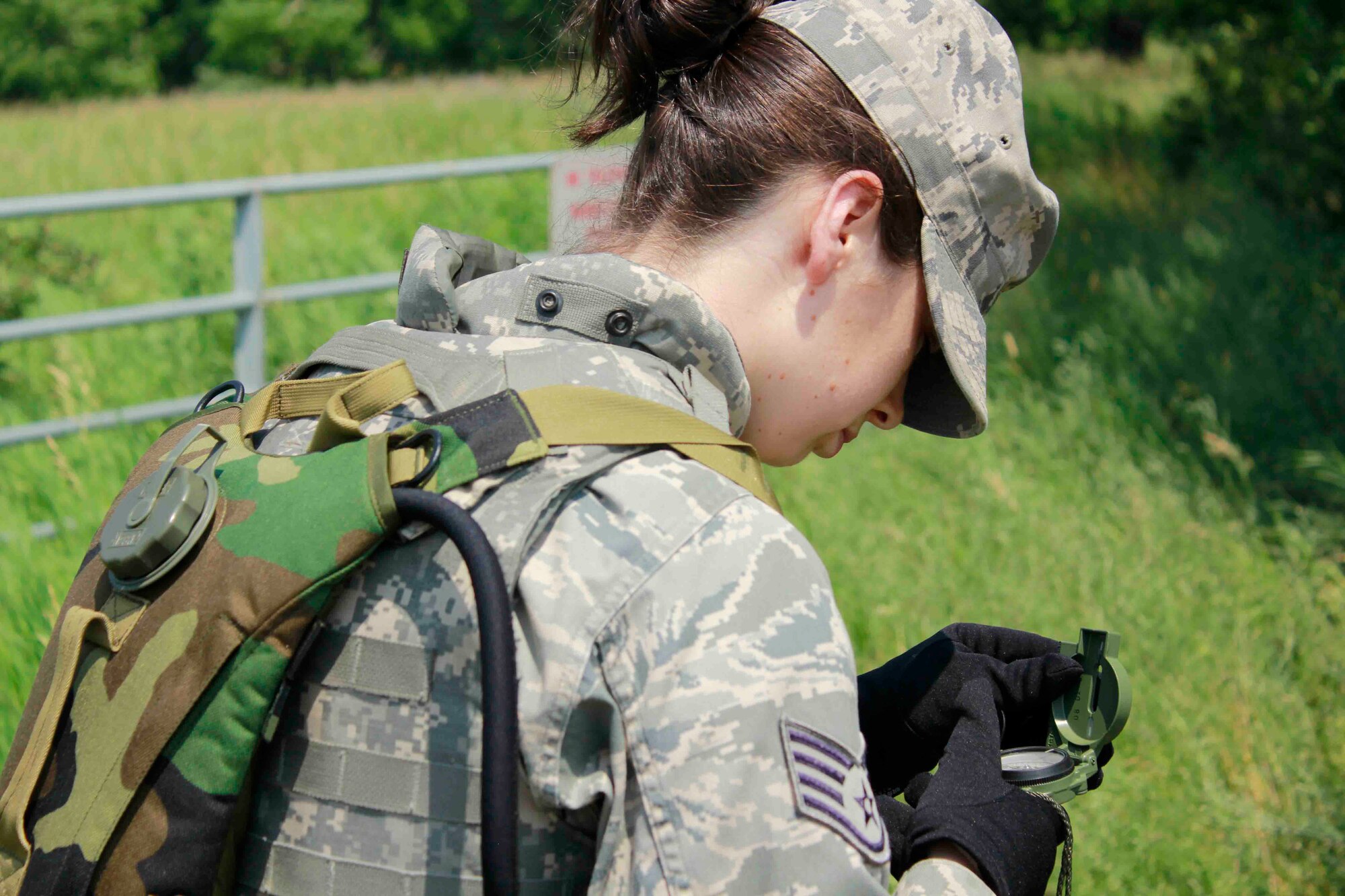 Staff Sgt. Elizabeth Hurrle calculates an azimuth using a compass. (Air Force Photo/Master Sgt. Nicollette Shegstad)
