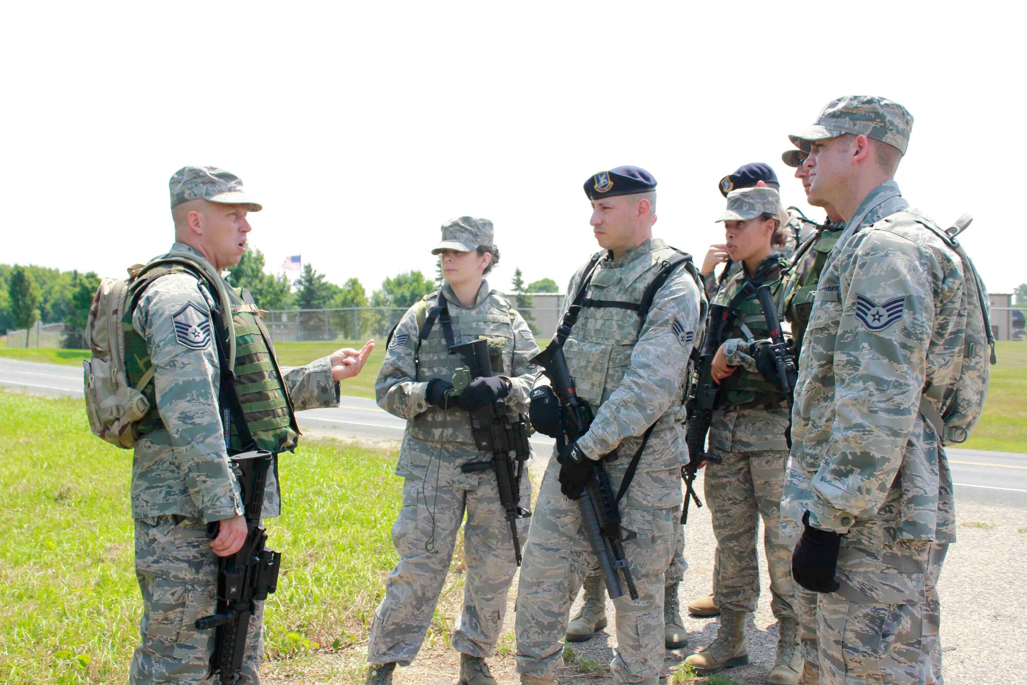 Master Sgt. Michael Bier explains the objectives of a foot patrol to his
squad.
(From left to right: Staff Sgt. Elizabeth Hurrle, Senior Airman Luis Lachuga, Airman Basic Felicia McGee and Staff Sgt. Justin Peterson) (Air Force Photo/Master Sgt. Nicollette Shegstad)
