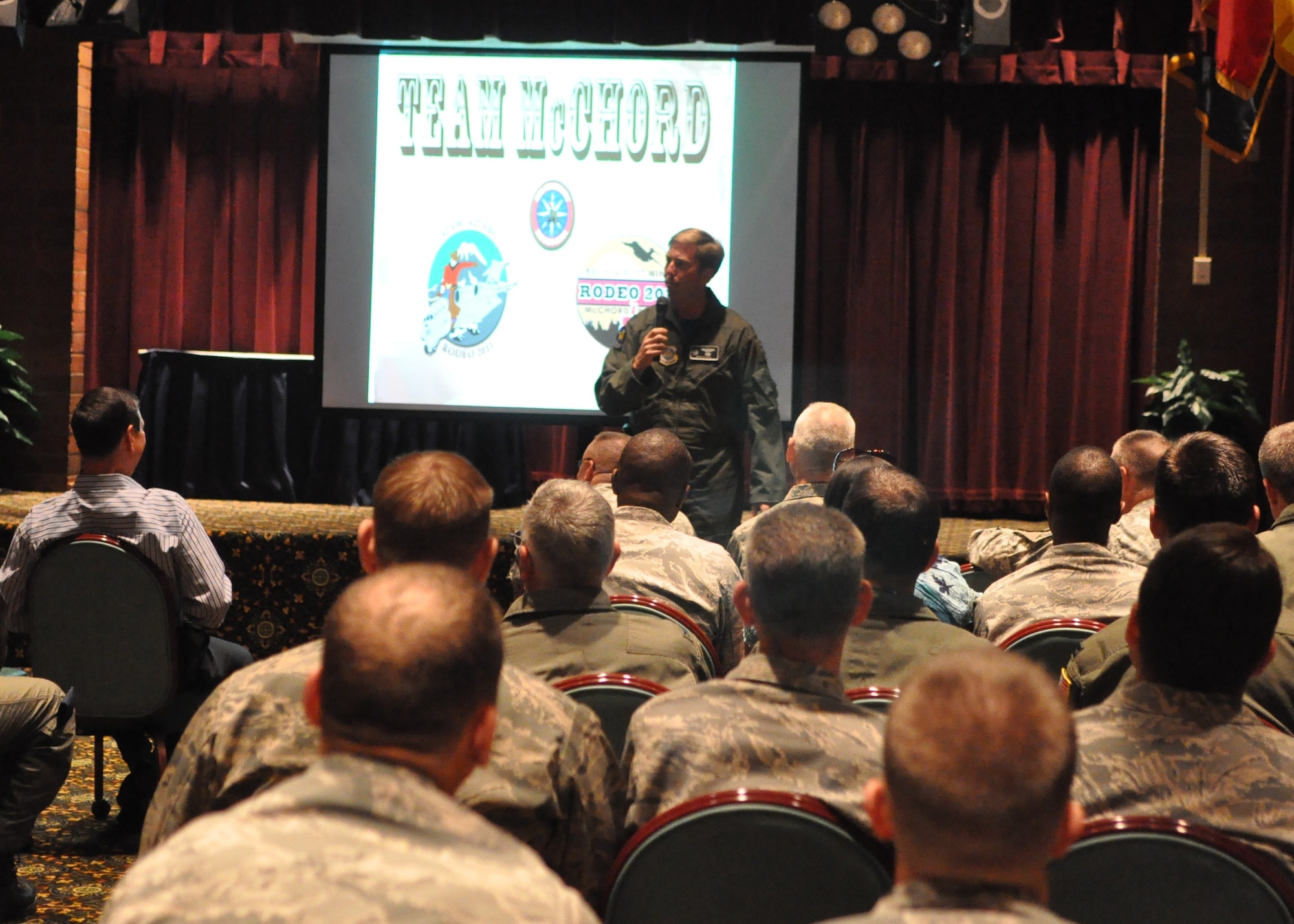 Col. R. Wyn Elder, 62nd Airlift Wing commander, speaks to Airmen at the RODEO Team Introduction July 8 at Joint Base Lewis-McChord, Wash. The combined 62nd Airlift Wing and 627th Air Base Group teams introduced at the meeting include aircrew, maintainers, finance experts, aerial porters and security forces. (U.S. Air Force photo/Airman 1st Class Leah Young)