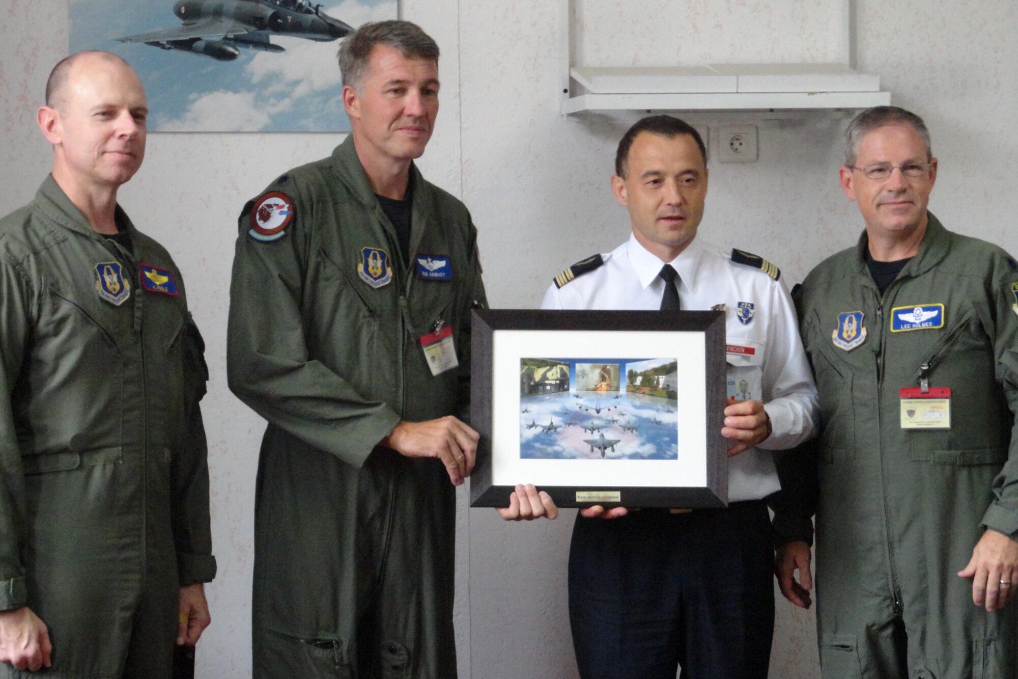 (L to R) Lt. Col. Lee Holmes, director of operations for the 343rd Bomb Squadron, Lt Col. Robert VanHoy II, 93rd Bomb Squadron, B-52 Instructor/aircraft commander, French air force Colonel Vinchon, the base commander of B.A.-125 (air base 125) and Lt. Col. Alan Ringle, chief mission planner, 307th Operations Support Flight, pose for a photo for a French photographer during a presentation ceremony after flybys for the “Lafayette Escadrille.” A collection of Barksdale Airmen paid tribute to aviation history last week by conducting two B-52H Stratofortress flyovers at the “Meeting De l’Air De Luxeuil” air show at Luxeuil air base, France.  The annual air show was held in conjunction with the 95th anniversary of the French air force’s legendary “Lafayette Escadrille,” which is currently stationed at Luxeuil. (Courtesy photo)