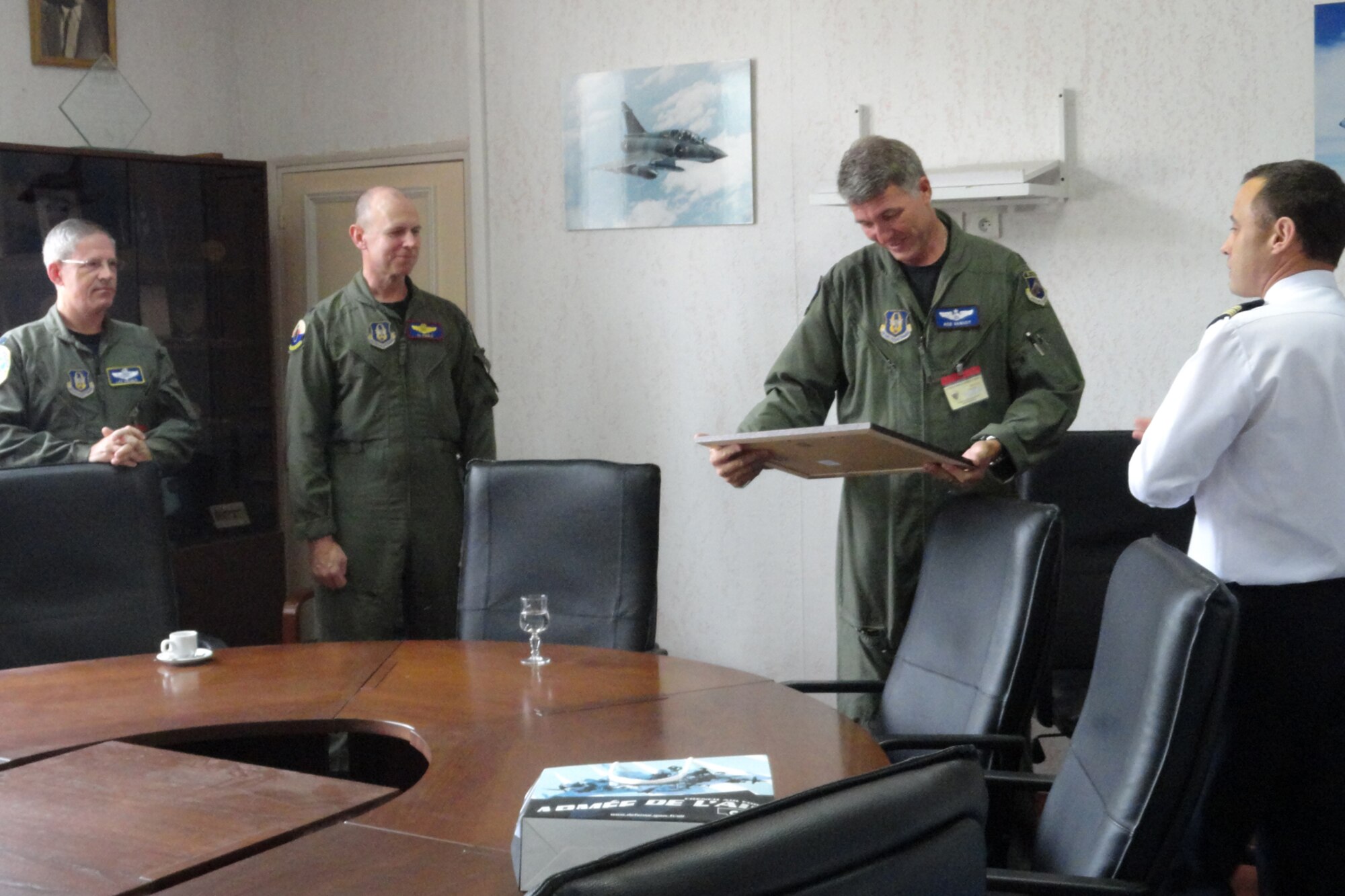 Lt Col. Robert VanHoy II, a 93rd Bomb Squadron B-52 Instructor/aircraft commander, accepts a gift from French air force Colonel Vinchon, the base commander of B.A.-125 (air base 125) during a presentation ceremony July 4, 2011. Also at the presentation (from far left) were Lt. Col. Lee Holmes, director of operations, 343rd Bomb Squadron, and Lt. Col. Alan Ringle, chief mission planner, 307th Operations Support Flight. A collection of Barksdale Airmen paid tribute to aviation history last week by conducting two B-52H Stratofortress flyovers at the “Meeting De l’Air De Luxeuil” air show at Luxeuil air base, France.  The annual air show was held in conjunction with the 95th anniversary of the French air force’s legendary “Lafayette Escadrille,” which is currently stationed at Luxeuil. (Courtesy photo)
