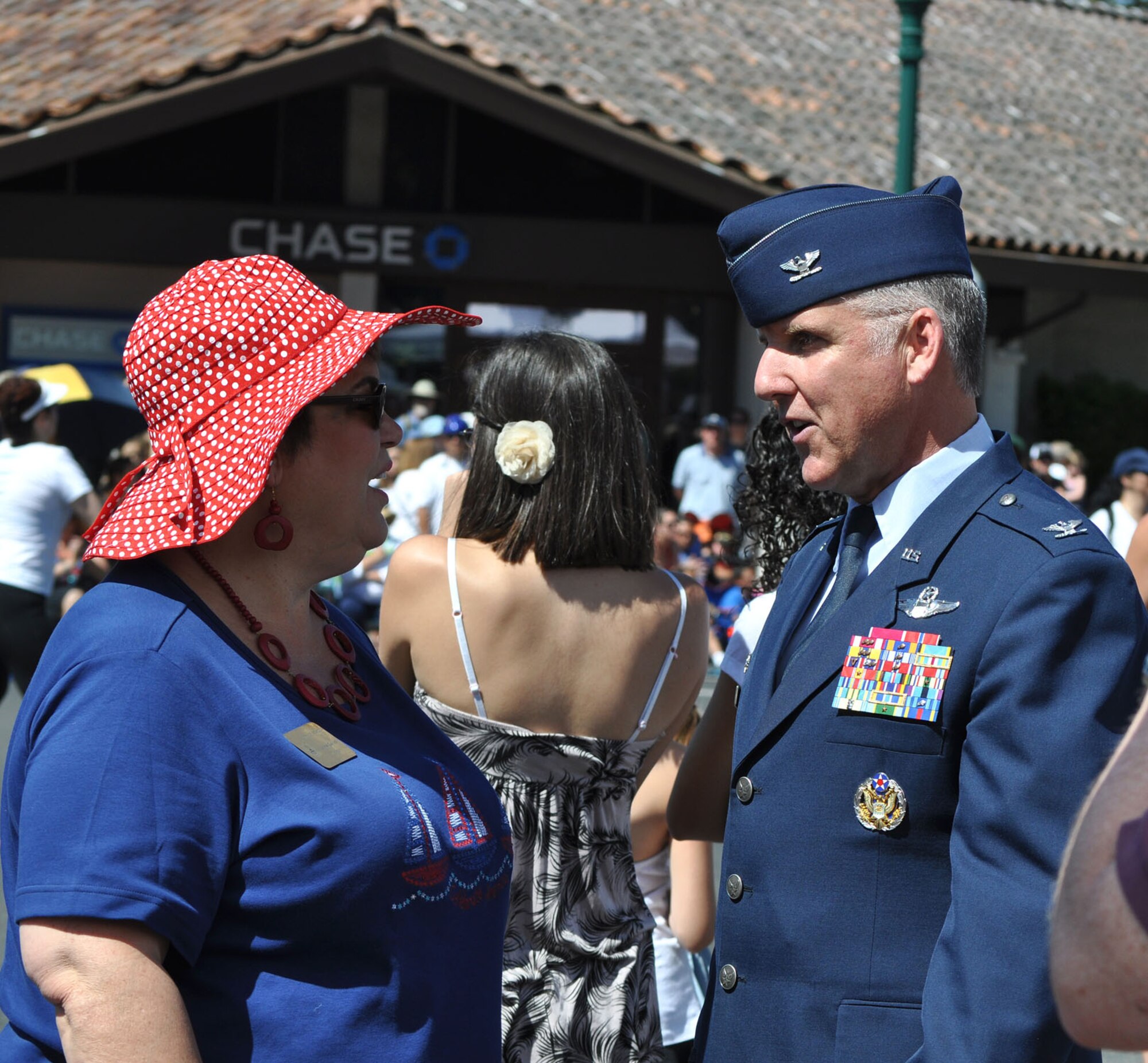 TRAVIS AIR FORCE BASE, Calif.-- Col. Jay Flournoy, 349th Air Mobility Wing commander, chats with Sonoma Mayor, Laurie Gallian, at the town's annual Fourth of July parade and celebration on the town plaza. Col. Flournoy rode in the parade with Robert Arnold, grandson of General Henry Harley "Hap" Arnold. Mayor Gallian and parade organizers invite the Travis Airmen out yearly to share in their local celebration, which hosts about 10,000 visitors. (U.S. Air Force photo/Senior Master Sgt. Ellen L. Hatfield)