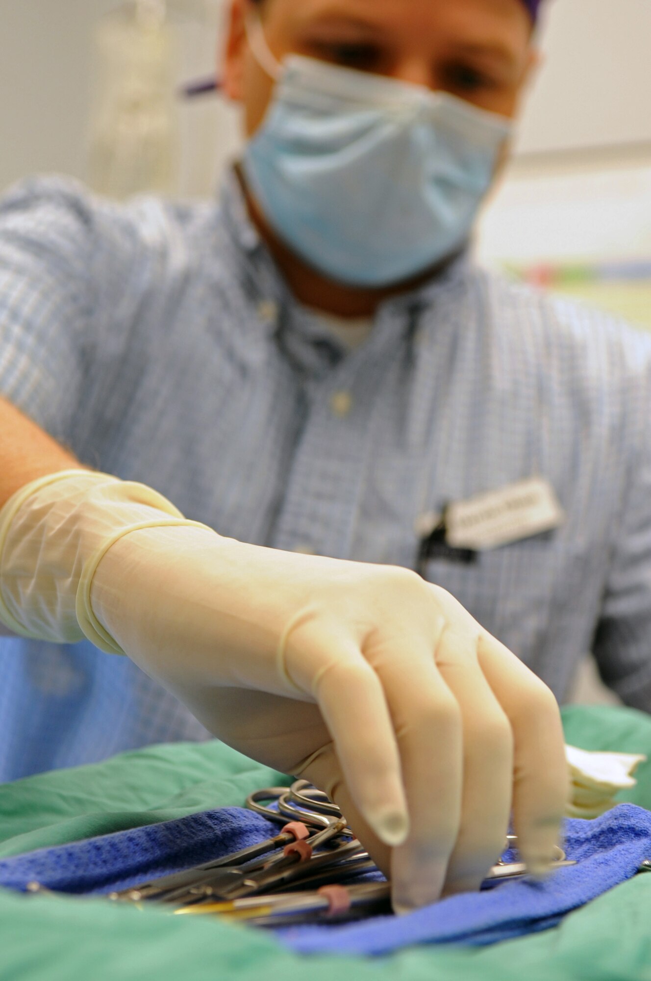 Veterinarian Dr. Darrin Olson reaches for a surgical instrument at the vet clinic on Barksdale Air Force Base, La., April 13. The clinic hours are Monday through Friday 9 a.m. to 12 p.m. and 1:30 p.m. to 4 p.m. The clinic is closed on weekends, federal holidays and the last working day of each month. (U.S. Air Force photo/Airman 1st Class Micaiah Anthony)(RELEASED)