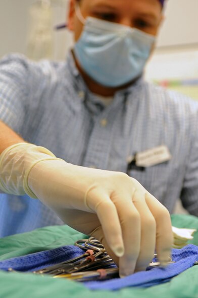 Veterinarian Dr. Darrin Olson reaches for a surgical instrument at the vet clinic on Barksdale Air Force Base, La., April 13. The clinic hours are Monday through Friday 9 a.m. to 12 p.m. and 1:30 p.m. to 4 p.m. The clinic is closed on weekends, federal holidays and the last working day of each month. (U.S. Air Force photo/Airman 1st Class Micaiah Anthony)(RELEASED)