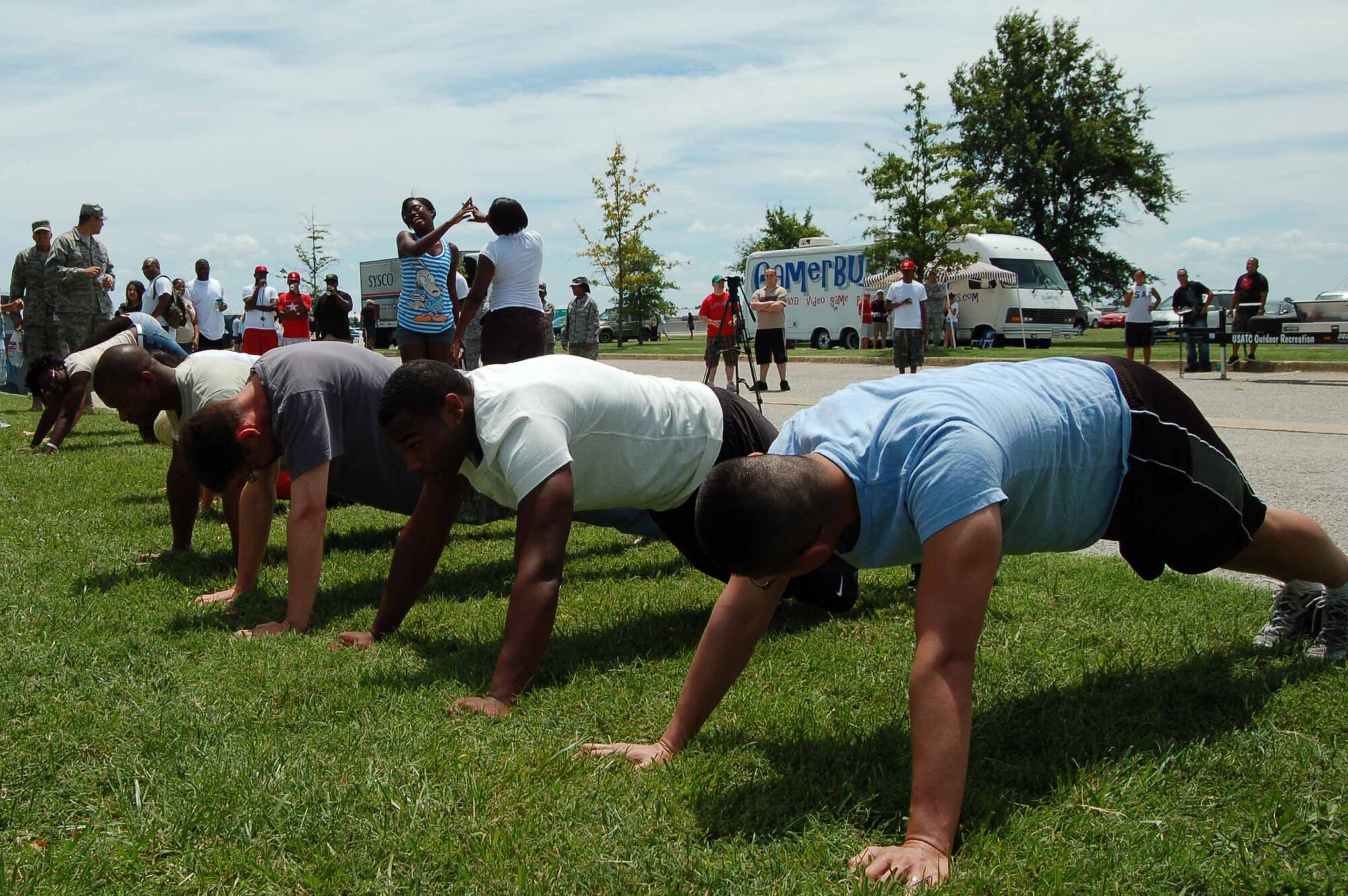 Contestants line up in the exercise position during a competition at Junior Enlisted Appreciation Day at Langley Air Force Base, Va., July 15, 2011.  Ten junior enlisted members were challenged to remain in the “up” push-up position for as long as possible.  Senior Airman Jessica Walker, 633rd Communication Squadron, and Airman 1st Class Monroe McAnuff, 1st Maintenance Squadron, persevered and were each awarded an Air Force physical training uniform.  (U.S. Air Force photo by Senior Master Sgt. Anna Hayman/Released)