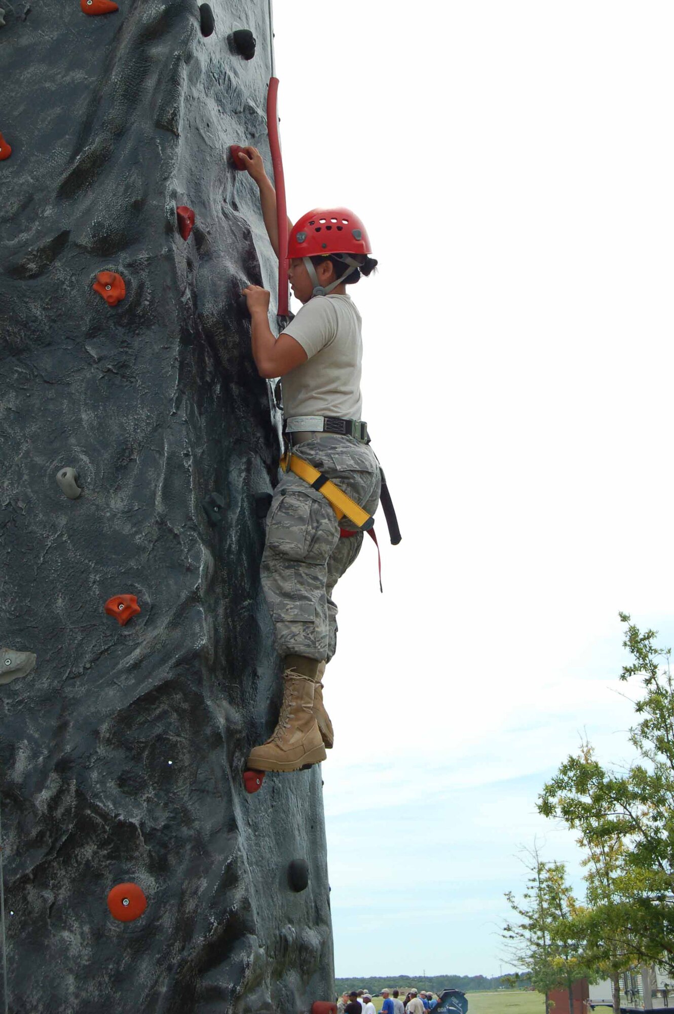 Airman 1st Class Phuong Lim, 1st Operations Group intelligence analyst, scales the mobile rock wall at Junior Enlisted Appreciation Day at Langley Air Force Base, Va., July 15, 2011.  The rock wall was one of many activities enlisted members in grades E-6 and below participated in throughout the day.  JEAD is an annual event in which agencies and organization from around the base come together to provide food and fun for hardworking junior enlisted members.  (U.S. Air Force photo by Senior Master Sgt. Anna Hayman/Released)