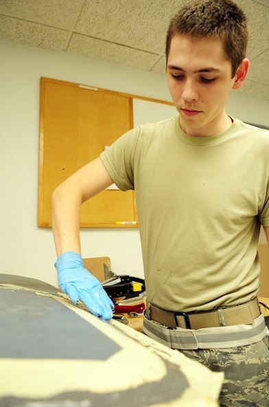 Senior Airman Brandon Bright, 2nd Maintenance Squadron, replaces an aerodynamic smoother on a gunner hatch for a B-52H Stratofortress at Barksdale Air Force Base, La., July 18. The smoother will make the hatch more aerodynamic, which will prevent rain from getting under the hatch. (U.S. Air Force photo/Senior Airman Joanna M. Kresge)