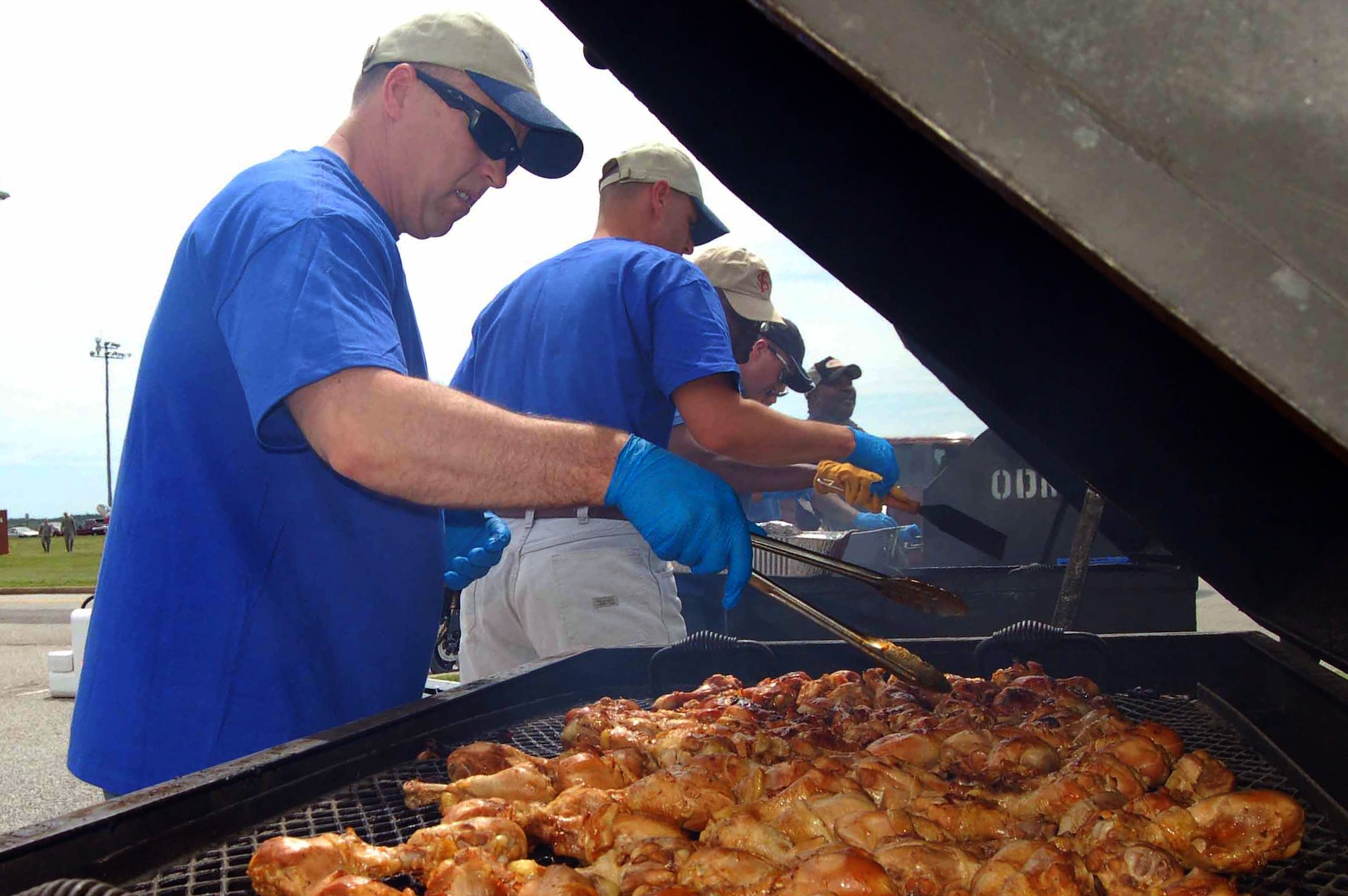 Chief Master Sgt. Rodney Goodman, 633rd Logistics Readiness Squadron materiel management chief, lends his grilling expertise to prepare chicken during Junior Enlisted Appreciation Day at Langley Air Force Base, Va., July 15, 2011.  Agencies and organization around the installation joined together to show enlisted members in the grades of E-6 and below how much their hard work is appreciated.  In addition to food, the event was filled with games, activities, music and prizes.  (U.S. Air Force photo by Senior Master Sgt. Anna Hayman/Released)