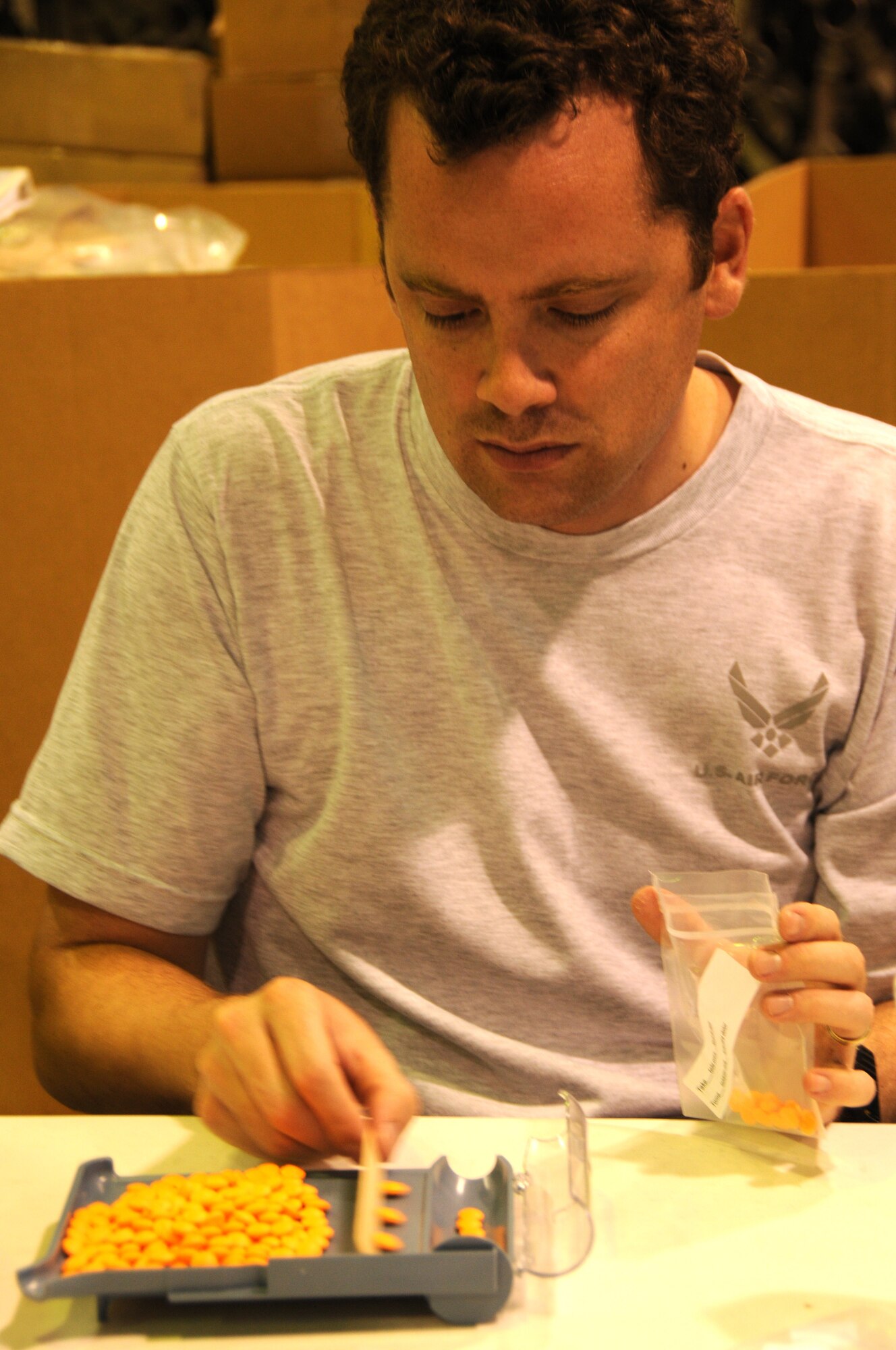 Capt. Mark Donaway, a dentist with the 916th Aerospace Medicine Squadron, sorts a bulk supply of aspirin into individual doses here July 16, 2011. The 916th AMDS is preparing to treat thousands of patients during a two-week-long humanitarian mission to Central America in August. (USAF photo by A1C Meredith Thomas, 916ARW/PA)