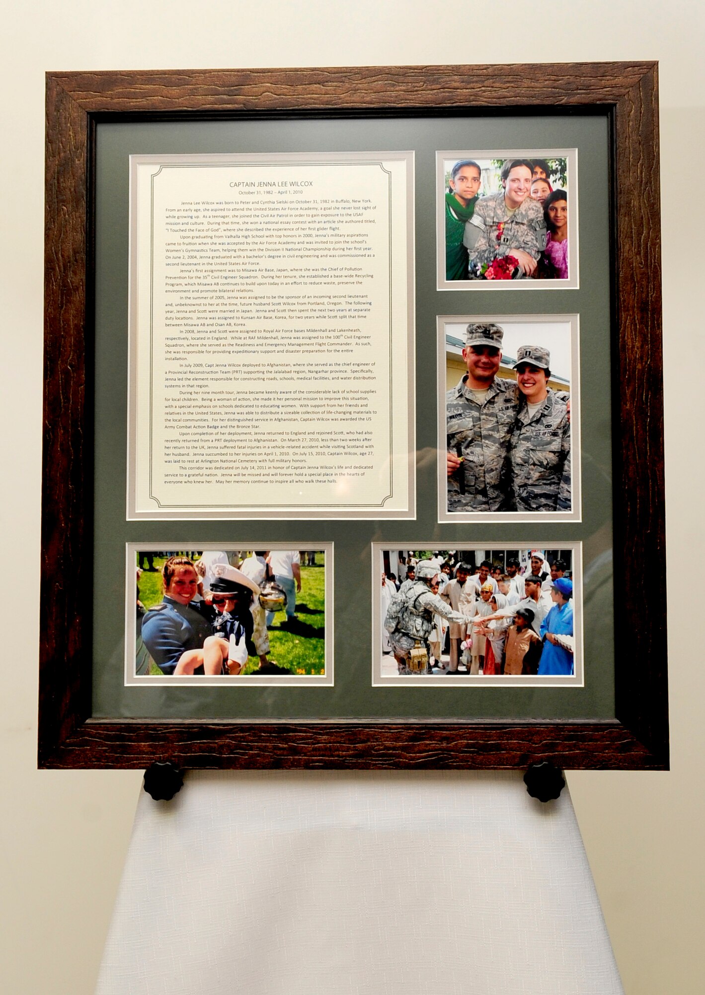 RAF MILDENHALL, England – A memorial tribute to Capt. Jenna Wilcox sits on display at the 100th Civil Engineer Squadron headquarters building during a dedication ceremony July 14, 2011. The 100th CES dedicated a corridor in their headquarters building to Wilcox, a former 100th officer, who died April 1, 2010. (U.S. Air Force photo / Senior Airman Ethan Morgan)