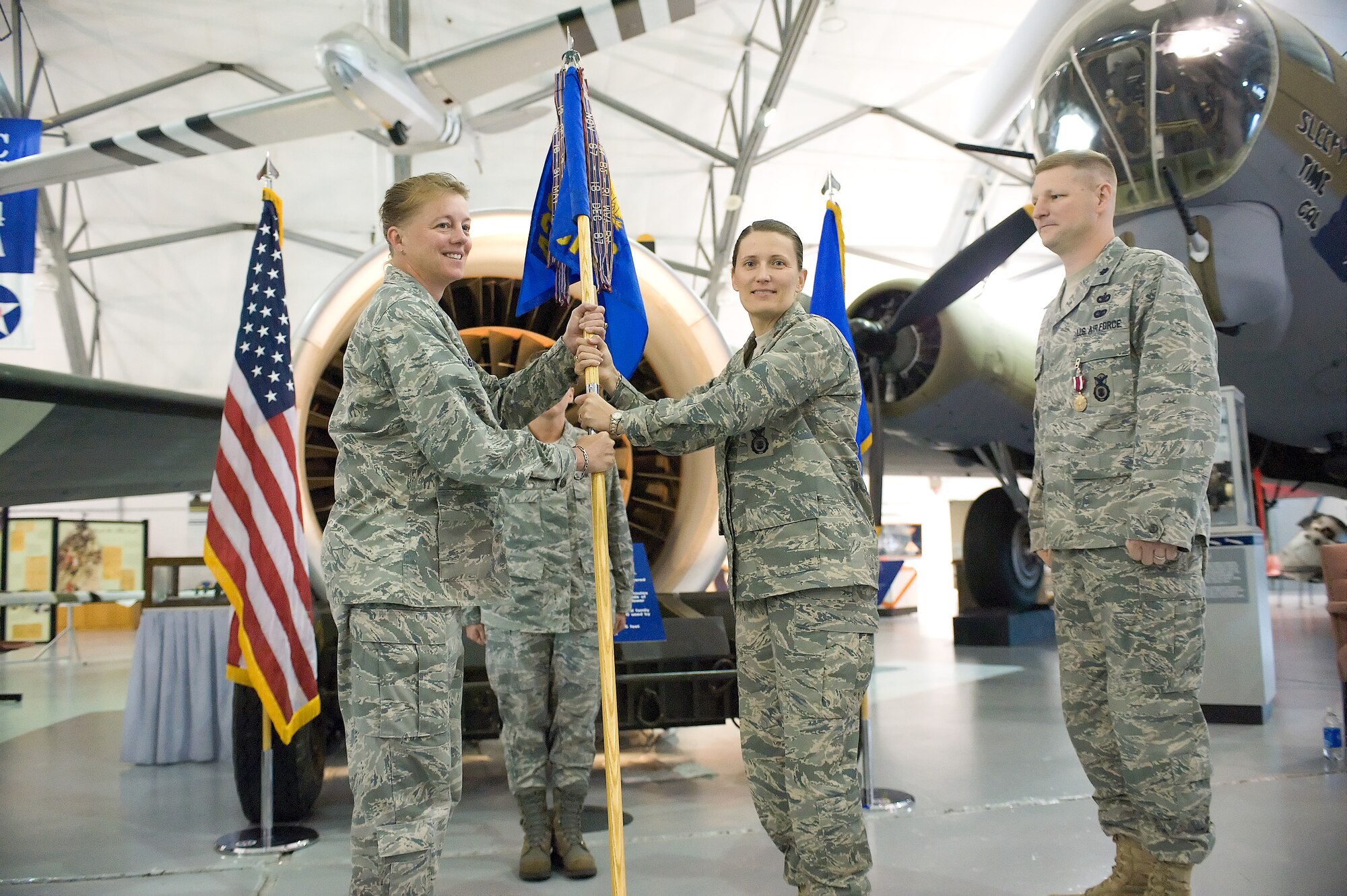 Col. Joan Garbutt (left), 436th Mission Support Group commander, passes the guidon to Maj. Melissa Brown as she takes command of the 436th Security Forces Squadron June 28, 2011, at Dover Air Force Base, Del. (U.S. Air Force photo by Roland Balik)