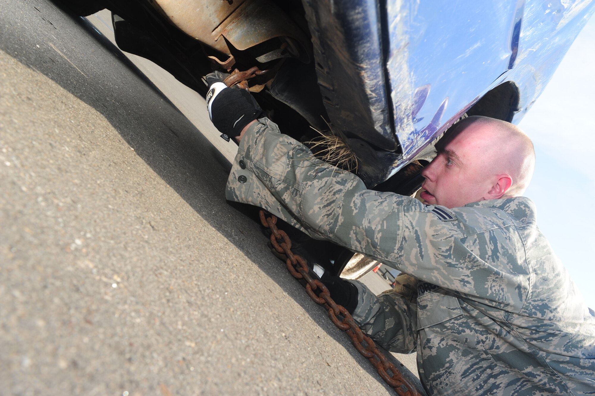 MINOT AIR FORCE BASE, N.D. -- Tech. Sgt. Bradley Williams, 5th Logistics Readiness Squadron vehicle operations supervisor, removes a chain from a rolled over trainer vehicle here July 13. Williams was recently recognized as one of the U.S. Air Force's 12 Outstanding Airmen of the Year. (U.S. Air Force photo/Senior Airman Michael J. Veloz)