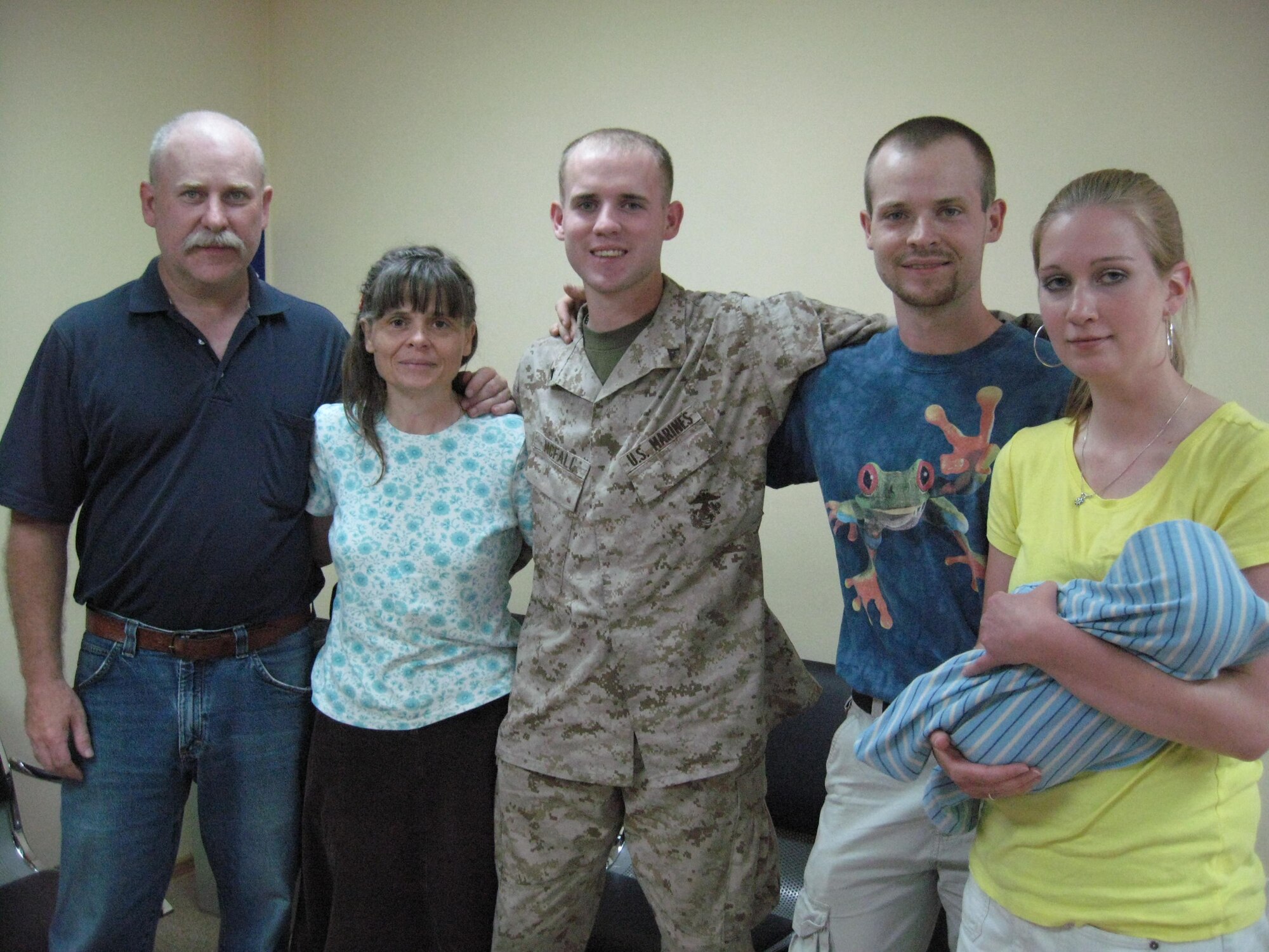 Marine Lance Cpl. Casey McFall hit the reunion jackpot while passing through the Transit Center at Manas, Kyrgyzstan, on his way to Afghanistan. He was able to spend the afternoon with his family. When McFall was 6 years old his family moved to Uzbekistan from the United States and then to Kyrgyzstan. McFall is assigned to the 2nd Radio Battalion as a crypto linguist at Camp Lejeune, N.C. (U.S. Air Force photo/Tech. Sgt. Tammie Moore)