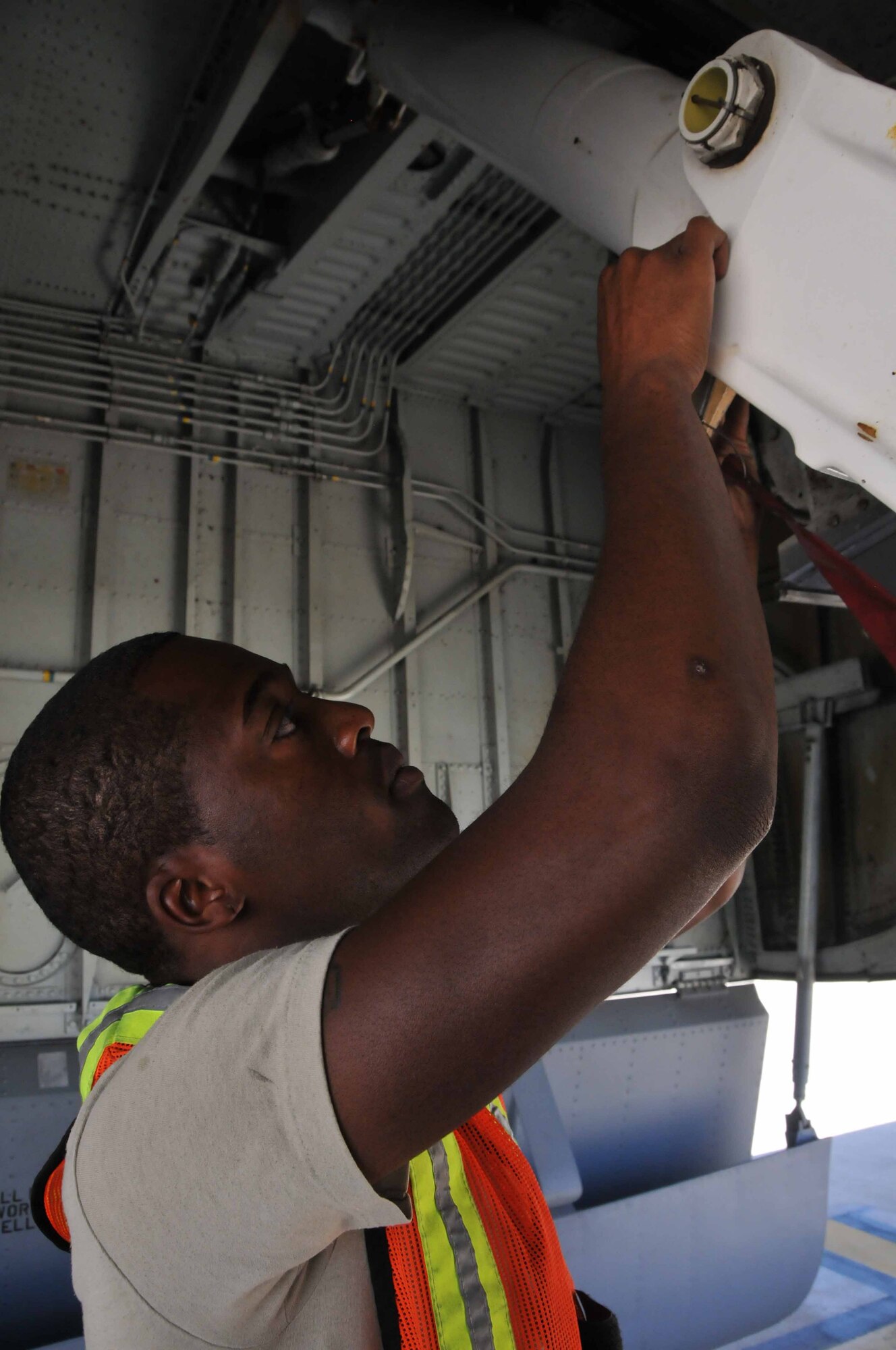 Senior Airman Brandon T. Jones installs a safety pin in the main landing gear of a KC-135 Stratotanker while deployed with the 313th Air Expeditionary Wing on July 18, 2011 in Western Europe. (U.S. Air Force photo/Capt. John P. Capra)