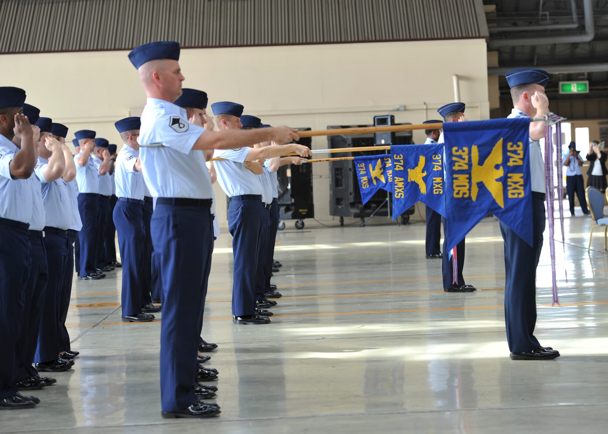 YOKOTA AIR BASE, Japan -- Airmen from the 374th Maintenance Group salute the flag during the playing of the National Anthem at the 374th MXG change of command ceremony at Yokota Air Base, Japan, July 18, 2011. (U.S. Air Force photo/Senior Airman Andrea Salazar)