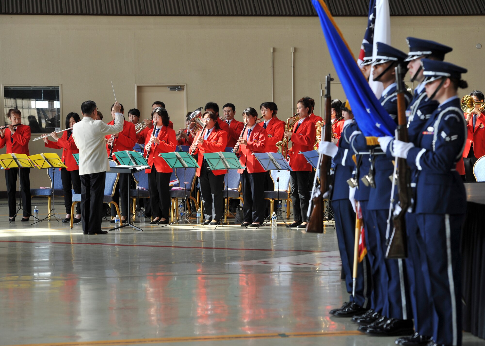YOKOTA AIR BASE, Japan -- The Mizuho Youth Symphonic Band, conducted by Mr. Hisatoshi Muta, plays the Japanese and American national anthems during the 374th Maintenance Group change of command ceremony at Yokota Air Base, Japan, July 18, 2011. (U.S. Air Force photo/Senior Airman Andrea Salazar)