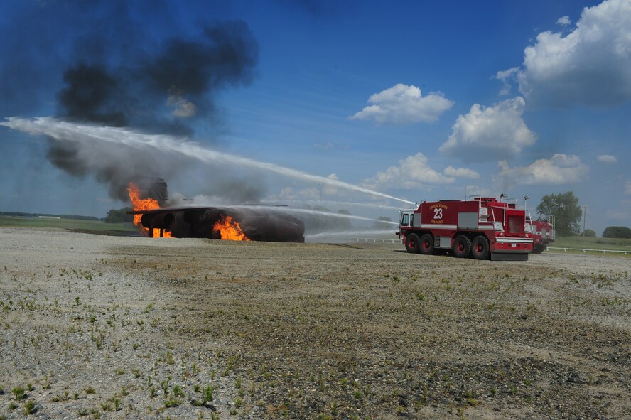 SEYMOUR JOHNSON AIR FORCE BASE, N.C. – A pair of fire trucks from the 4th Civil Engineer Squadron work to extinguish flame on a simulated downed aircraft here, July 18, 2011. This exercise was part of a large-scale operational readiness exercise that will run throughout the week. (U.S. Air Force photo by Senior Airman Rae Perry/RELEASED)