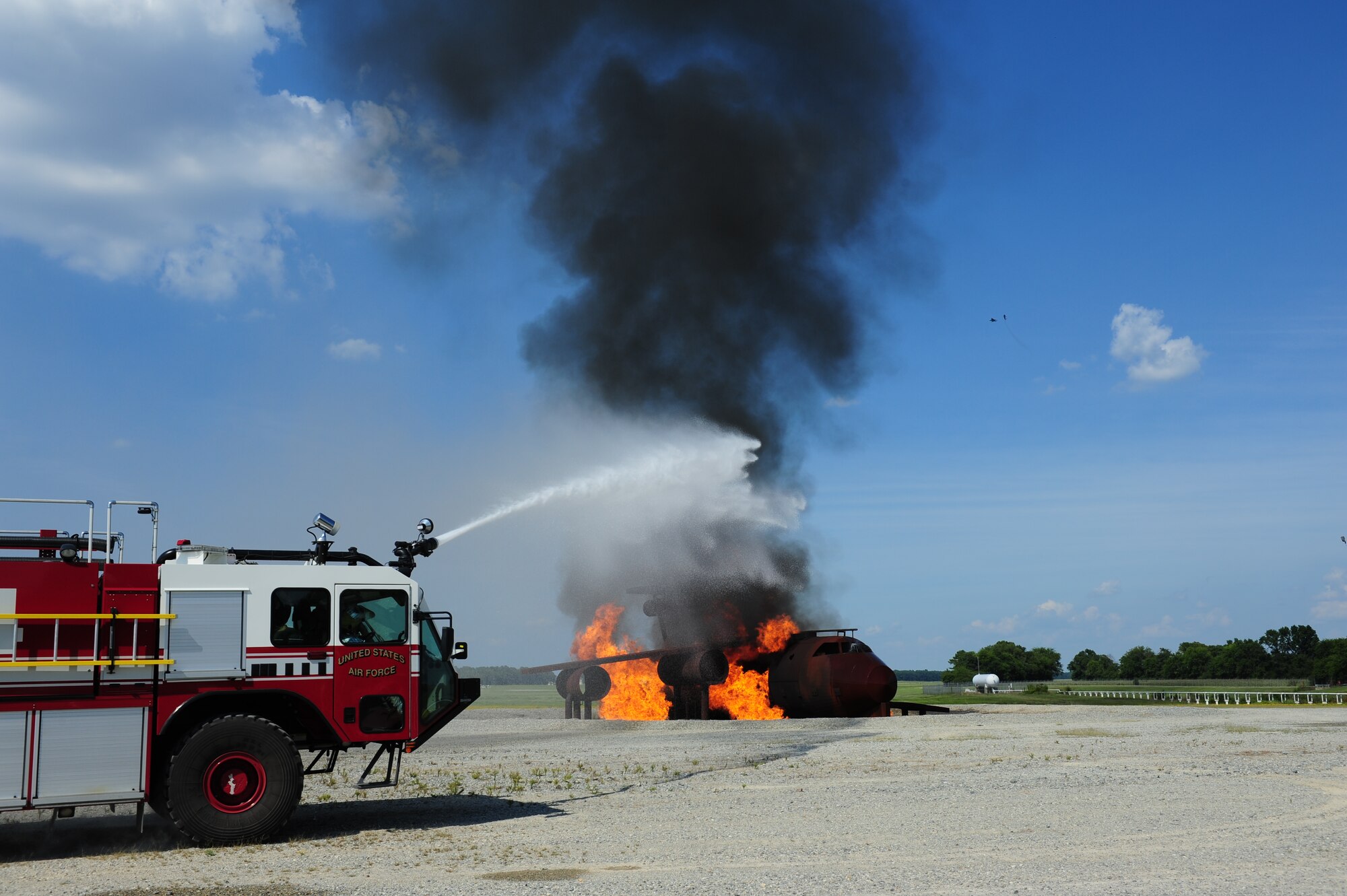 SEYMOUR JOHNSON AIR FORCE BASE, N.C. – A fire crew from the 4th Fighter Wing Civil Engineers Squadron work to extinguish flame on a simulated downed aircraft here, July 18, 2011. This exercise was part of a larger scale operational readiness exercise throughout the week. (U.S. Air Force photo/Senior Airman Rae Perry/RELEASED) 
