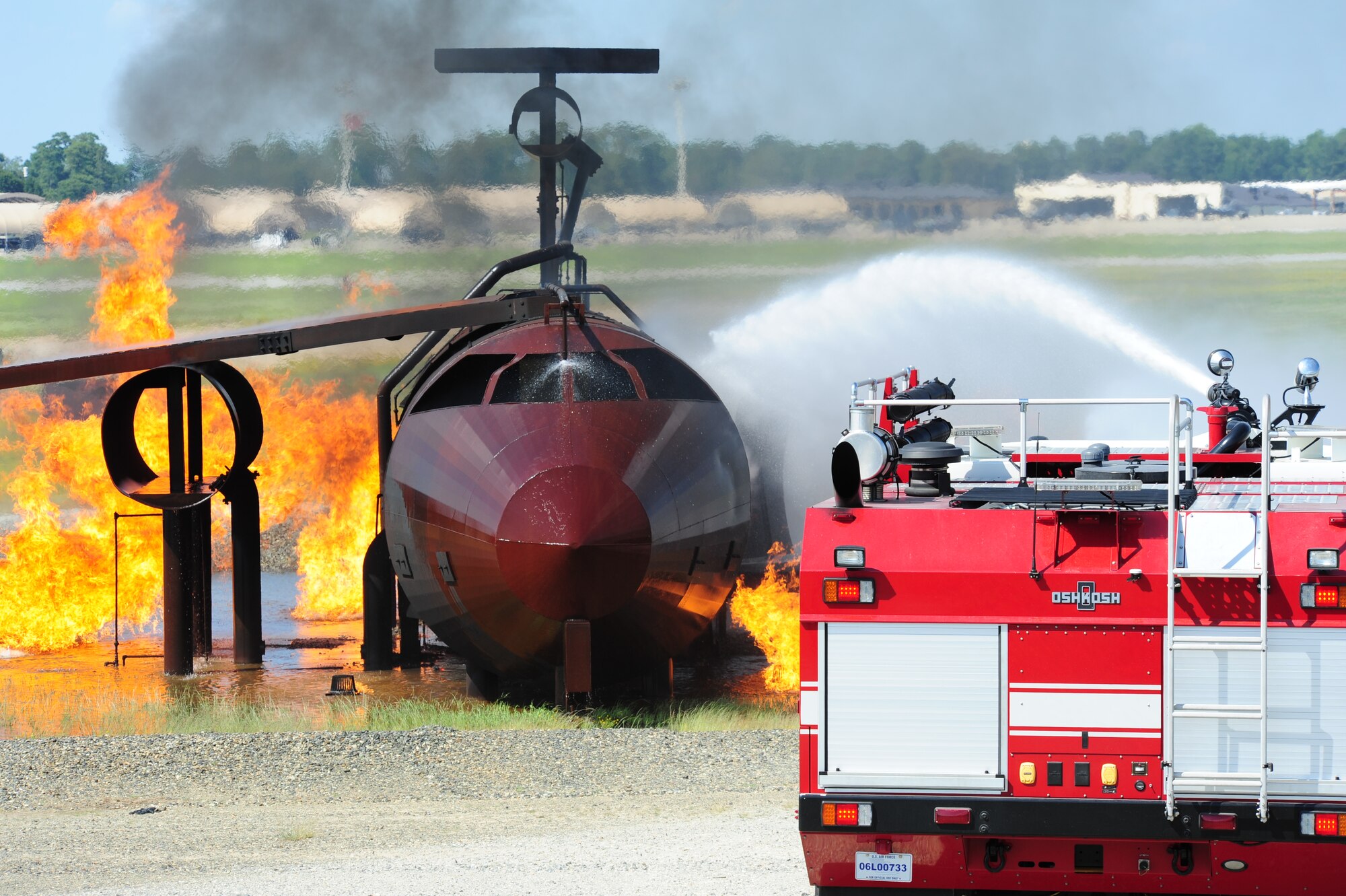 SEYMOUR JOHNSON AIR FORCE BASE, N.C. – A fire crew from the 4th Fighter Wing Civil Engineers Squadron work to extinguish flame on a simulated downed aircraft here, July 18, 2011. This exercise was part of a larger scale operational readiness exercise throughout the week. (U.S. Air Force photo/Senior Airman Rae Perry/RELEASED)