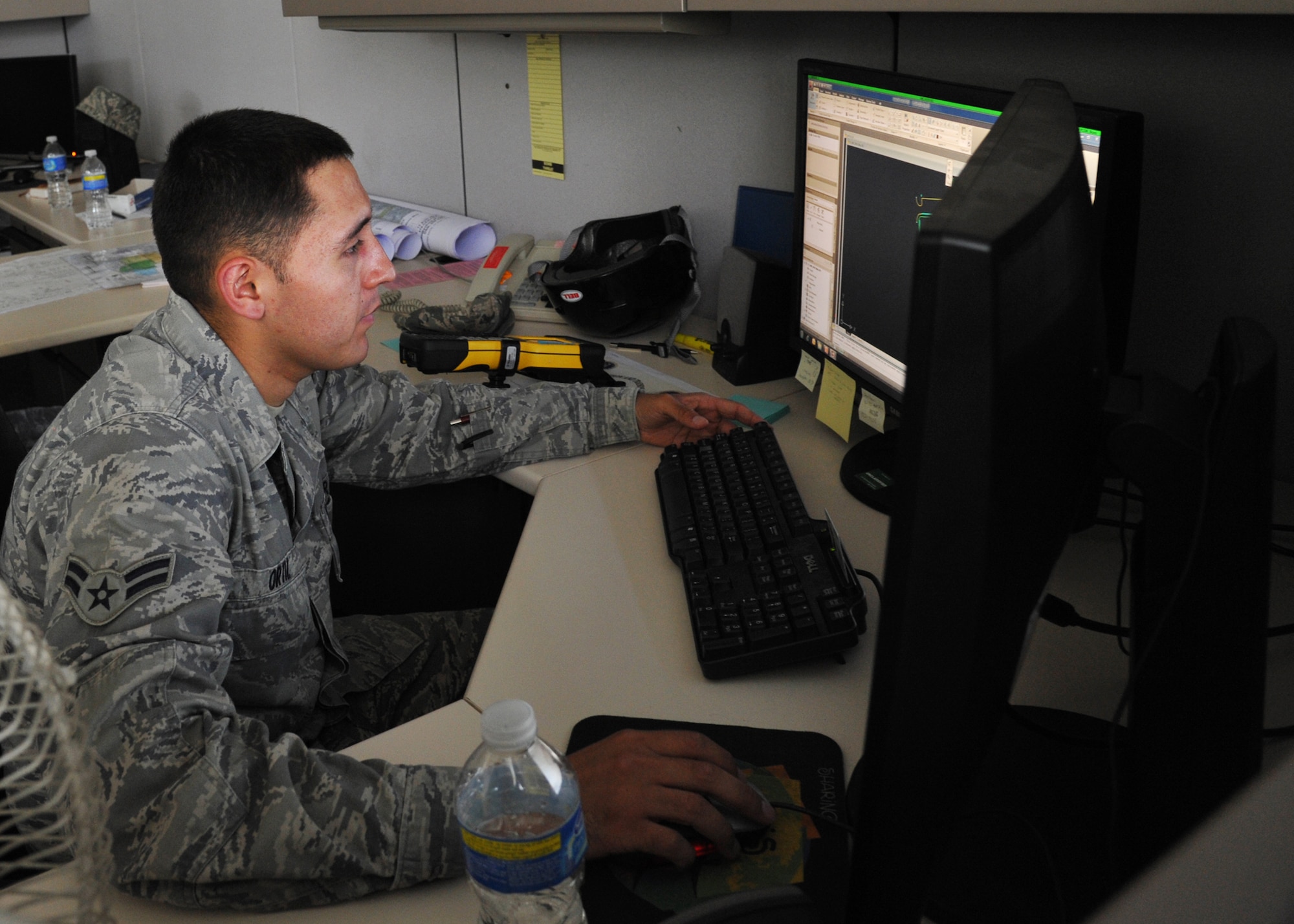 YOKOTA AIR BASE, Japan -- Airman 1st Class Carlos Ortiz, 374th Civil Engineer Squadron engineering technician, transfers a facility's survey data to the GeoBase system June 29, 2011, at Yokota Air Base, Japan. The GeoBase is a mapping tool for the entire base and allows anyone on the base?s computer network to view an aerial map of Yokota. (U.S. Air Force photo/Senior Airman Andrea Salazar)