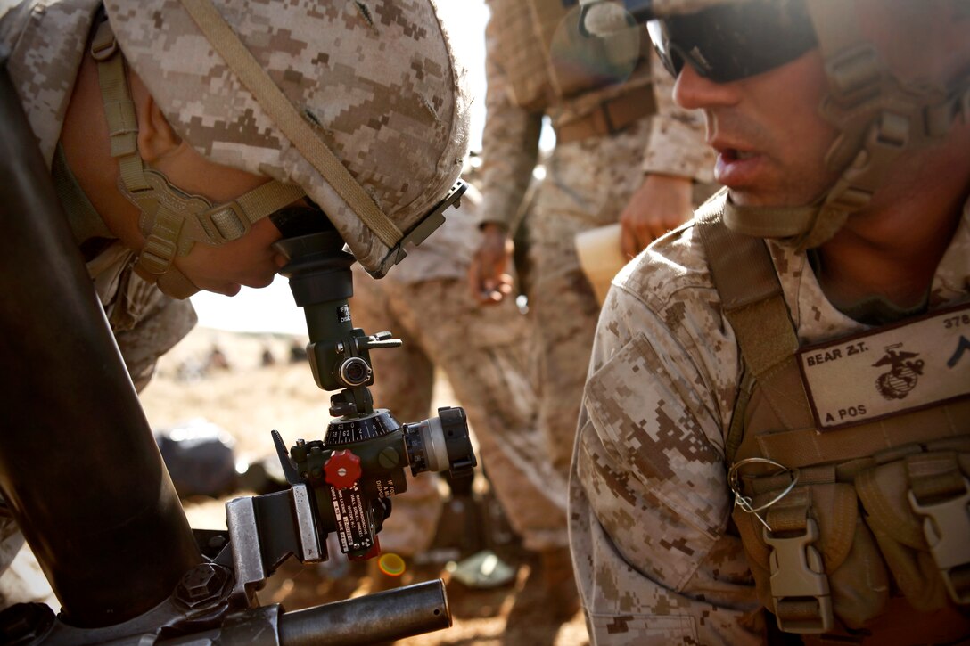 U.S. Marine Lance Cpl. Pedro A. Hernandez, left, and Pfc. Zachary T. Bear, right, prepare a M252 81 mm mortar system for a fire mission during Talisman Sabre 2011 on Townshend Island, Australia, July 13, 2011. Hernandez and Bear are mortarmen assigned to the 2nd Battalion, 7th Marine Regiment, 31st Marine Expeditionary Unit's battalion landing team.