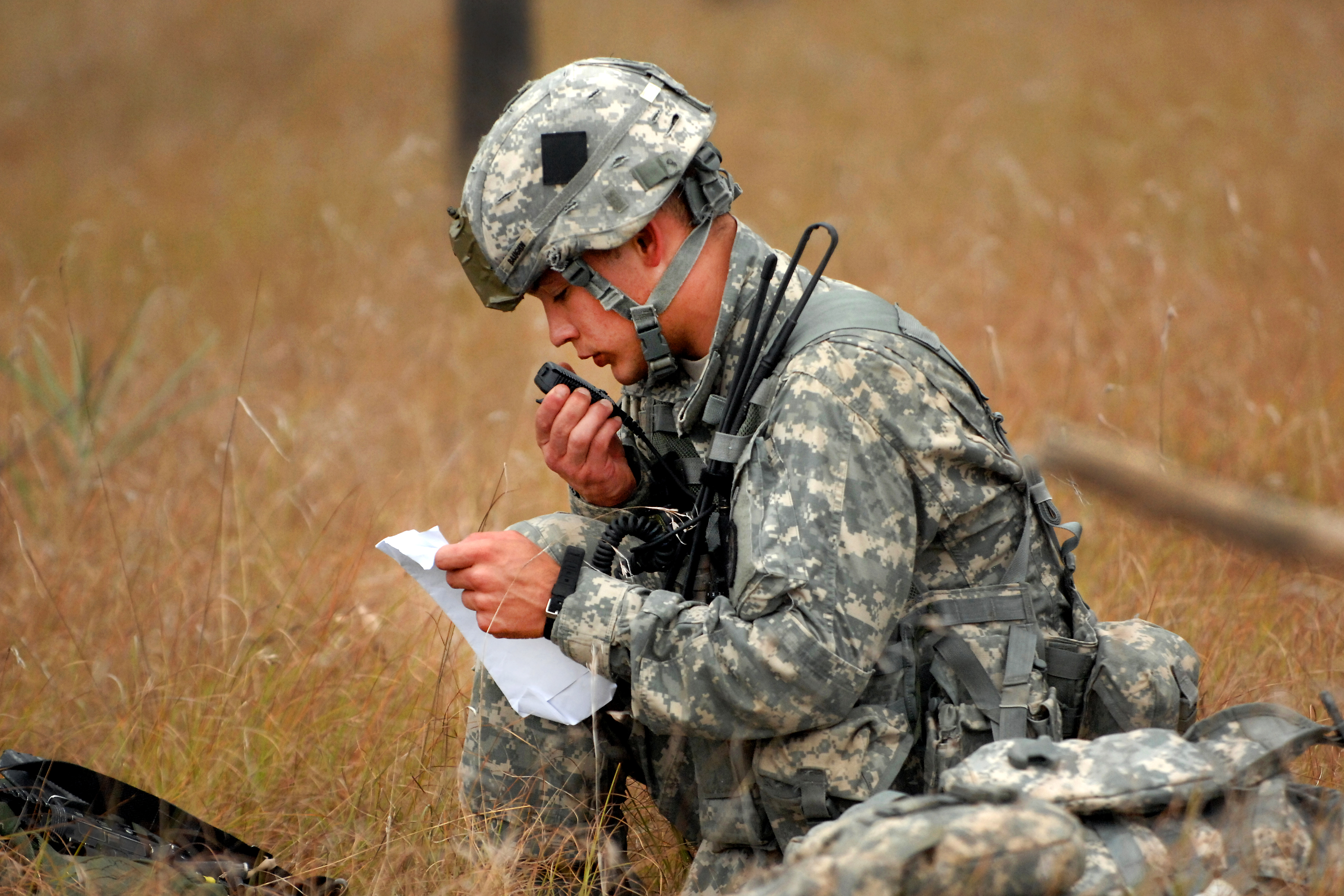 A U S Soldier Uses A Radio To Call His Unit S Grid Location After Parachuting Out Of