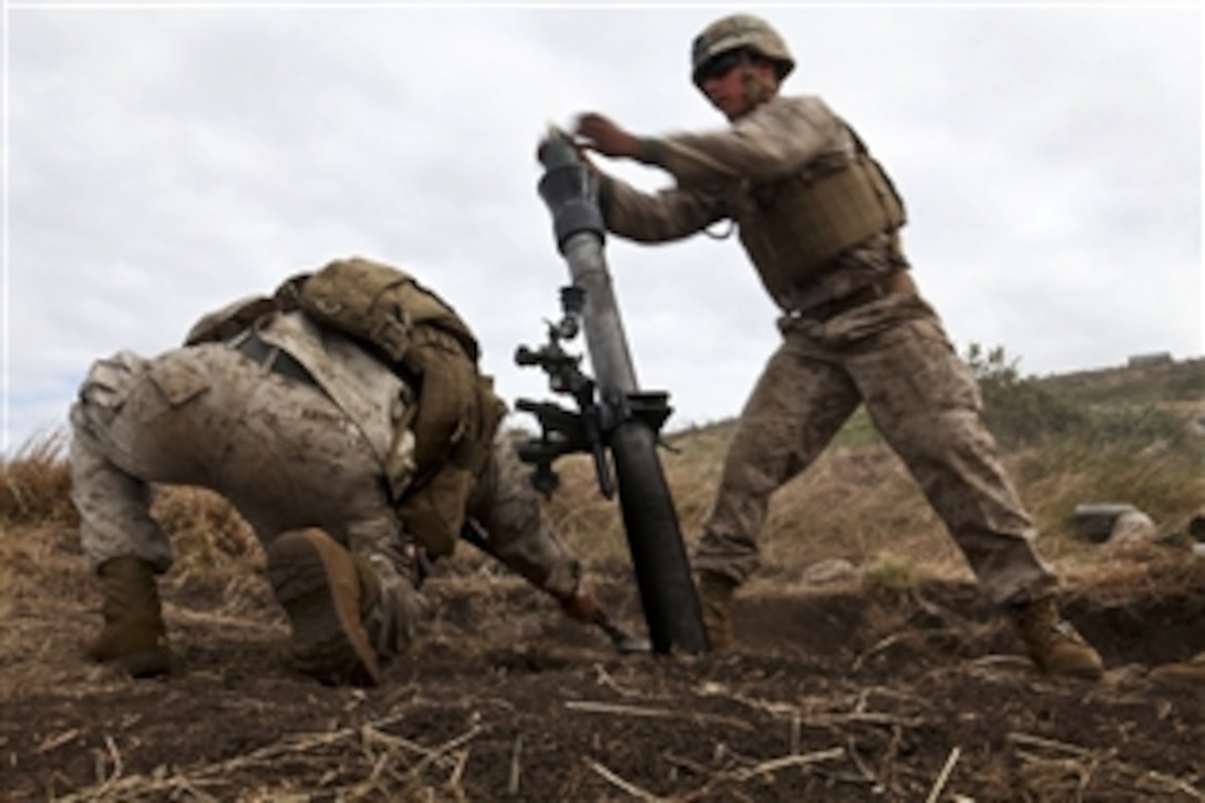 U.S. Marine Cpl. Samuel G. Potenti drops a mortar round into an M252 81mm mortar system during Talisman Sabre 2011 on Townshend Island, Australia, July 14, 2011.  The exercise demonstrates U.S. and Australian commitment to their military alliance, and enhances stability and security throughout the Asia-Pacific region. Polenti is a squad leader with Weapons Company, 2nd Battalion, 7th Marine Regiment, Battalion Landing Team, 31st Marine Expeditionary Unit.