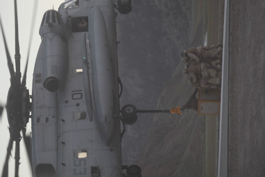 Marines with Support Company, Combat Logistics Battalion 44, hook up a 4,800 pound concrete block to a CH-53E Super Stallion, with Marine Heavy Helicopter Squadron-772, during Operation Javelin Thrust at Marine Corps Mountain Warfare Training Center July 19.