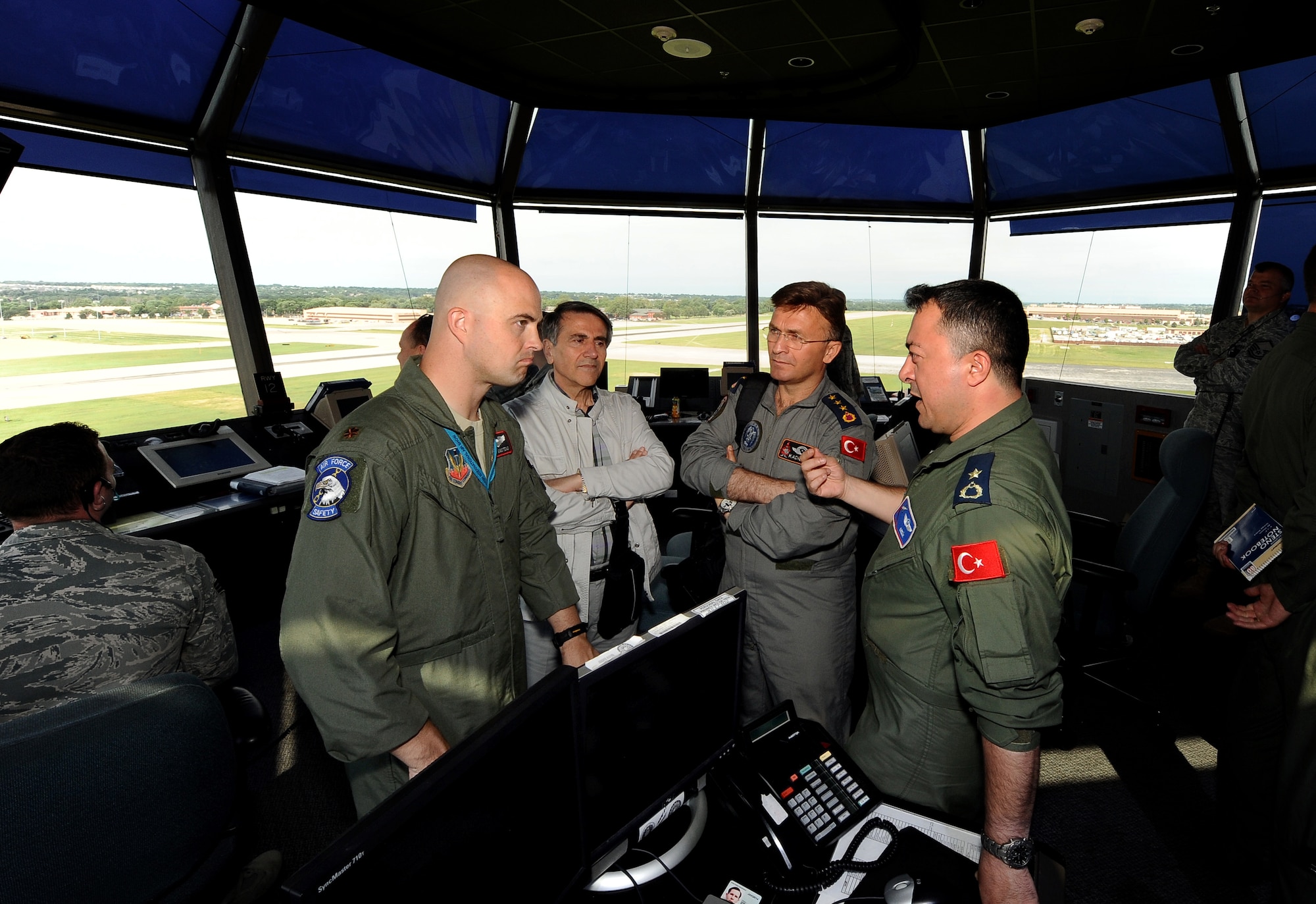 Airmen with the Turkish Air Force speak with Maj. Gavin Gigstead, 55th Wing chief of flight safety, regarding the MERLIN Avian Radar Warning System, inside Offutt's control tower, July 12. The Turkish Air Force is considering installing the same radar system to protect their aircraft and crew members from the potential damage caused by birds in and around runways.  (U.S. Air Force photo by Josh Plueger/Released)