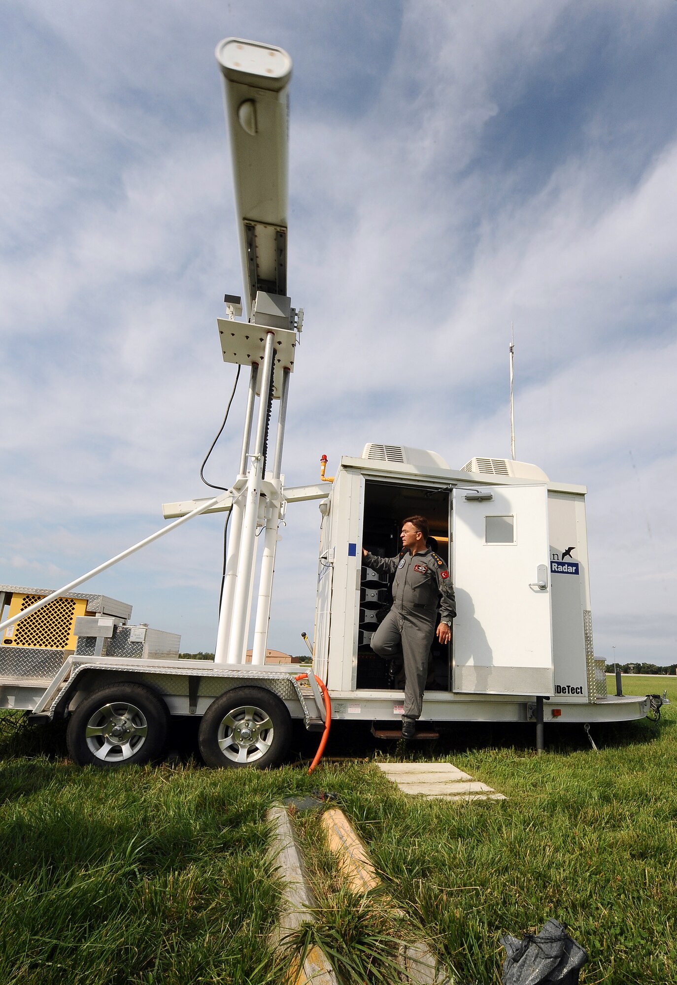 Turkish Air Force Col. Yasar Kadioglu walks out of the Merlin Avian Radar Warning System located on Offutt Air Force Base, July 12.  The radar system protects incoming and outgoing aircraft from local bird populations that can cause significant damage if they are sucked into an aircrafts engine.  (U.S. Air Force photo by Josh Plueger/Released)
