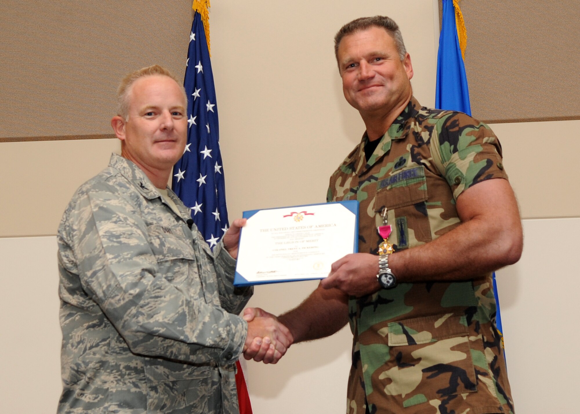 BUCKLEY AIR FORCE BASE, Colo. --  Colonel Daniel Dant, 460th Space Wing commander, awards the Legion of Merit to Col. Trent Pickering, 460th Space Wing vice commander July 15, 2011. After serving as the wing's vice commander for 2 years, Pickering will be moving on to the National Reconnaissance Office in Chantilly, Va. (U.S. Air Force photo by Airman1st Class Marcy Glass)
