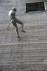 U.S. Air Force Capt. Nicholas Kuc, 820th Combat Operations Squadron chief of communications, repels down a seven-story wall during a demonstration at Moody Air Force Base, Ga., July 20, 2011. The demonstration’s purpose was to show the repelling and fast-roping capabilities of the 93rd Air Ground Operations Wing. (U.S. Air Force photo by Airman 1st Class Paul Francis/Released)
