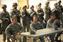 U.S. Air Force Col. Scott Kindsvater, 93rd Air Ground Operations Wing commander (left), Col. Randall Richert, 820th Base Defense Group commander (center), and Chief Master Sgt. Atticus Smith, 93rd AGOW command chief, listen in during a briefing at Moody Air Force Base, Ga., July 20, 2011. The brief covered the specifics of how Airmen would operate during a military operations in urban terrain demo. (U.S. Air Force photo by Airman 1st Class Paul Francis/Released)