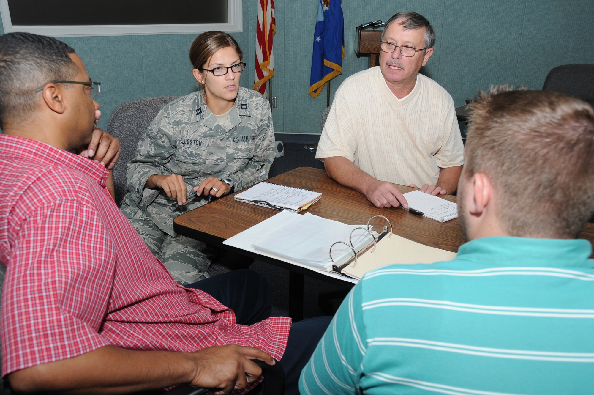 From left, Rodney McGruder, Capt. Cieara Clugston, Chuck Cerny and Joseph Turpin, 81st Communications Squadron, discuss the Command Cyber Readiness Inspection in the 81st CS conference room July 7.  Capt. Clugston is the lead for CCRI preperations.  (U.S. Air Force photo by Kemberly Groue)