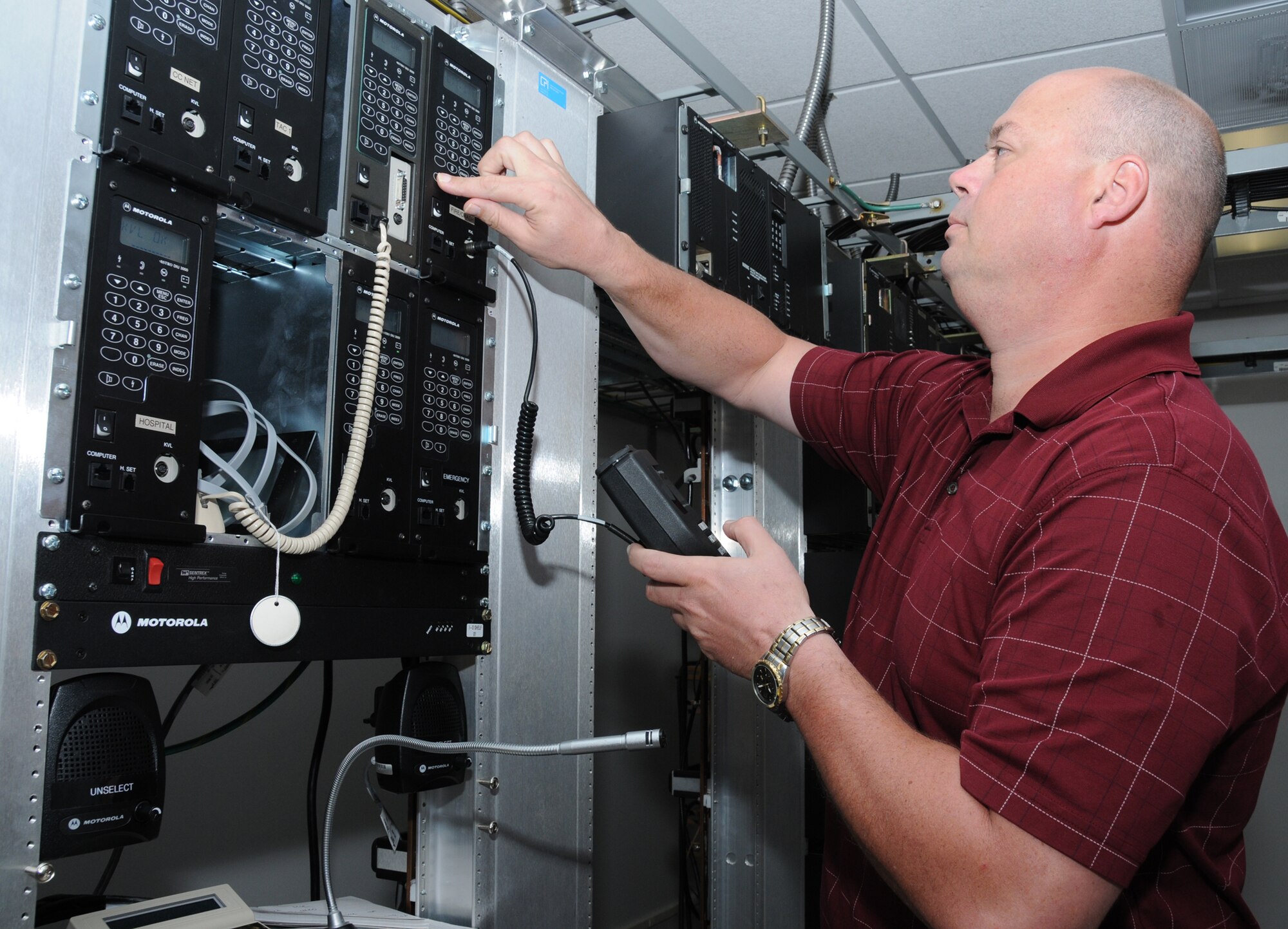 Jack Parnell, who works in the 81st Communications Squadron’s land mobile radio
section, keys an encryption module for the fire department that allows firefighters
to talk securely on their radios, July 7. The 81st CS, working through the challenges
of a military-to-civilian conversion and migration to a more centralized network,
keeps Keesler’s communication channels open.  (U.S. Air Force photo by Kemberly Groue)