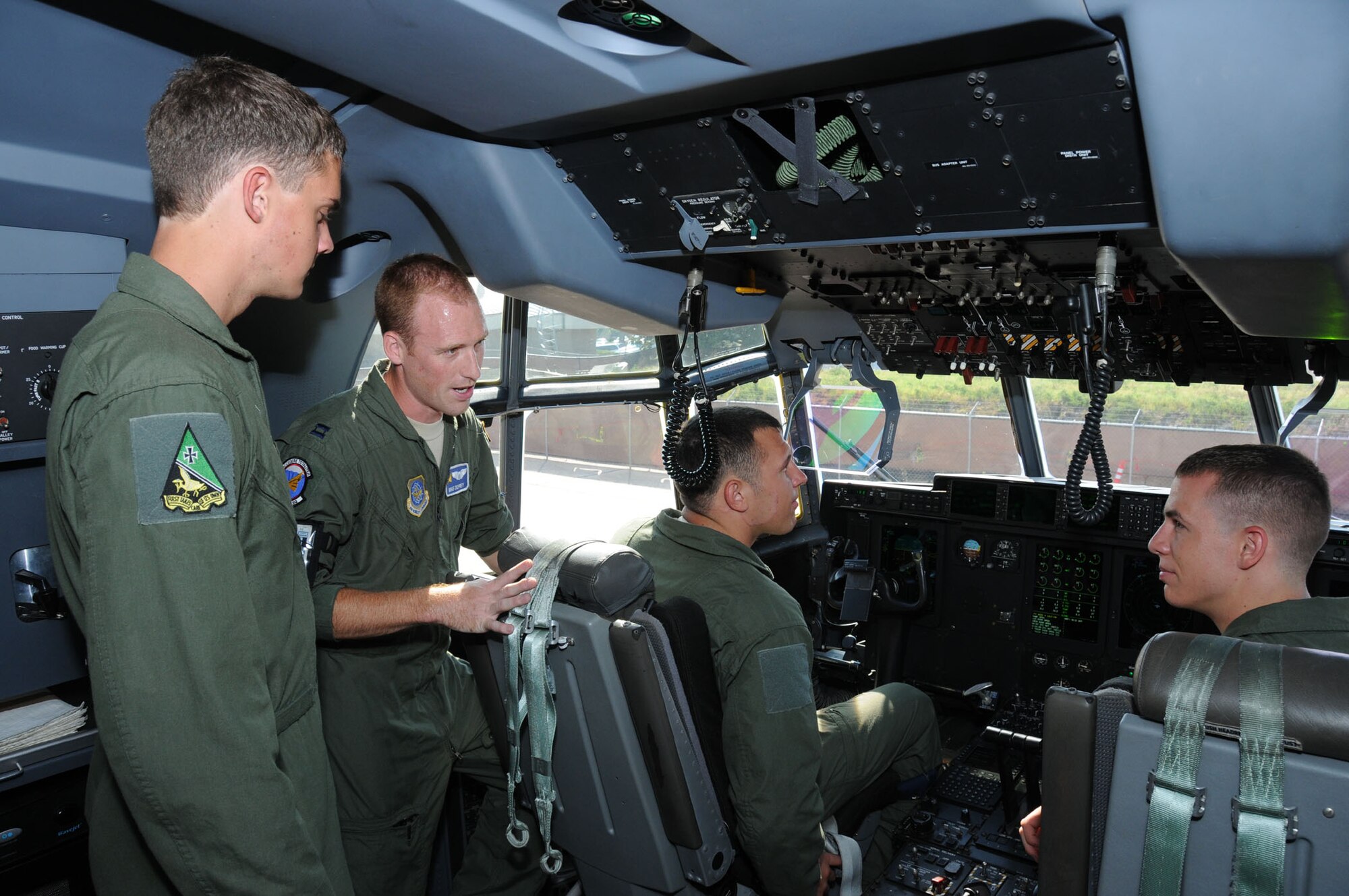 From left, Cadet Joseph Truxal, Capt. Mike Deprey, 345th Airlift Squadron, Cadet Mark Kaminski and Cadet Robert Gibson view the inside of a C-130 cockpit while receiving a briefing in preperation for flying from Deprey.  He also briefs the Air Force Academy cadets on the duties and responsibilities of being a pilot.  Operation Air Force is an annual program for Air Force Academy students to taste what the operational Air Force is really like.  (U.S. Air Force photo by Kemberly Groue)