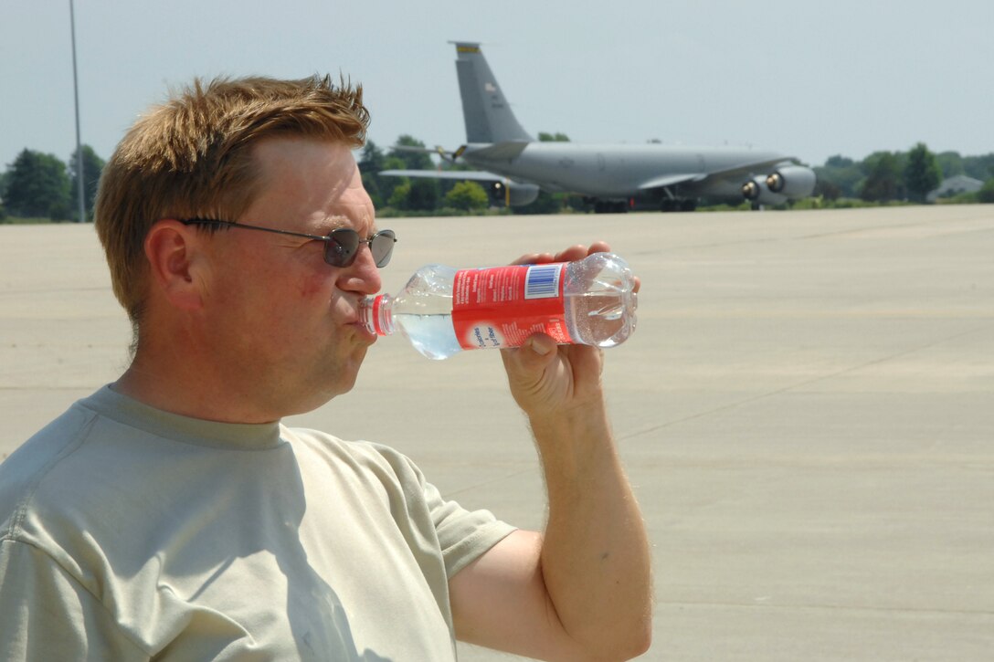 Technical Sgt. Carl Tyynismaa takes a drink of water after spending the day Monday, July 18, 2011 working on a KC-135 Stratotanker aircraft at Selfridge Air National Guard Base, Mich. The heat index on the flight line was above 100 degrees in mid-afternoon, causing Airmen at the base to drink extra water and take regular breaks in the shade. Tyynismaa is a crew chief assigned to the 127th Wing, Michigan Air National Guard, at the base. (USAF photo by Rachel Barton)