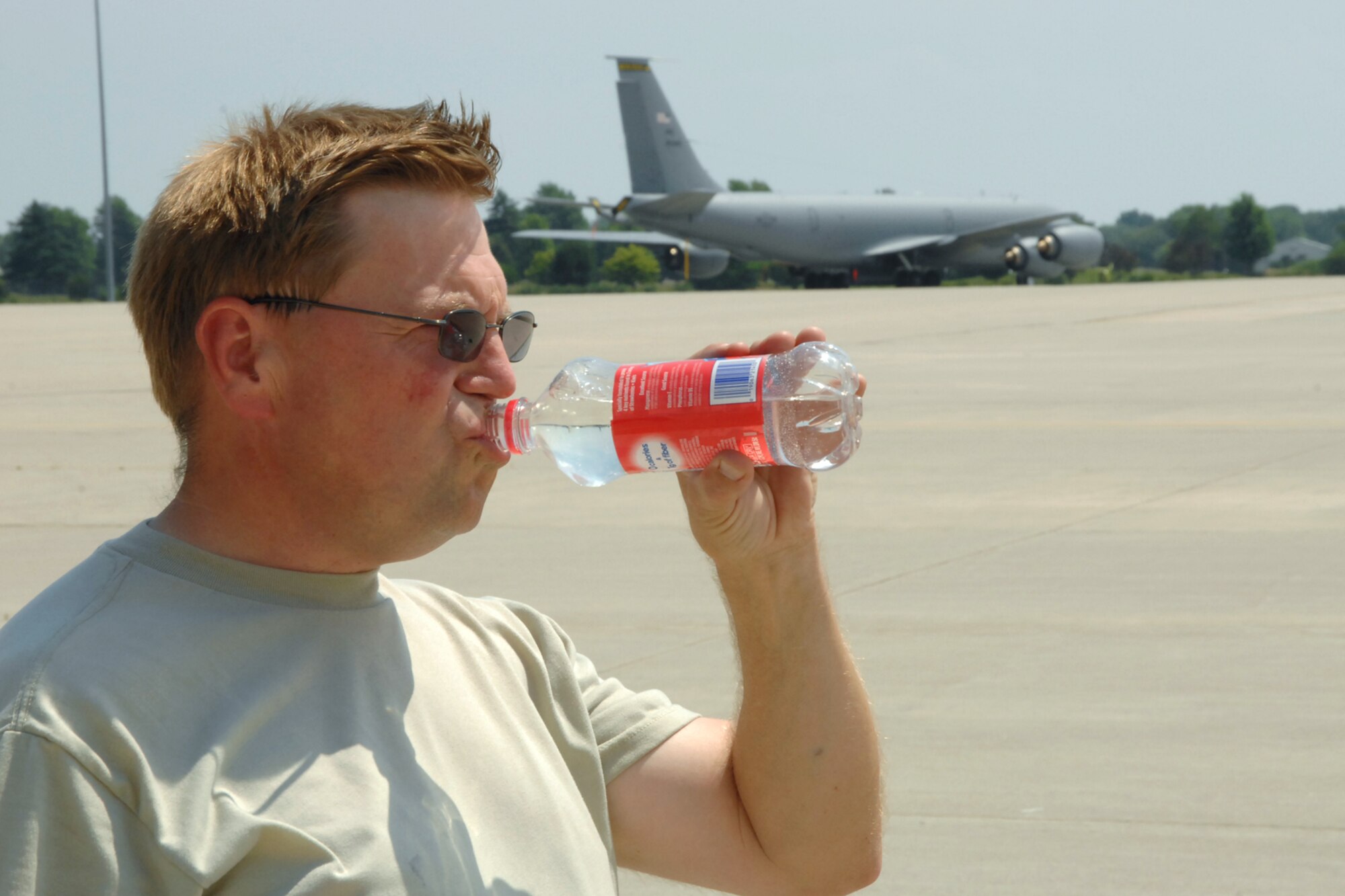 Technical Sgt. Carl Tyynismaa takes a drink of water after spending the day Monday, July 18, 2011 working on a KC-135 Stratotanker aircraft at Selfridge Air National Guard Base, Mich. The heat index on the flight line was above 100 degrees in mid-afternoon, causing Airmen at the base to drink extra water and take regular breaks in the shade. Tyynismaa is a crew chief assigned to the 127th Wing, Michigan Air National Guard, at the base. (USAF photo by Rachel Barton)