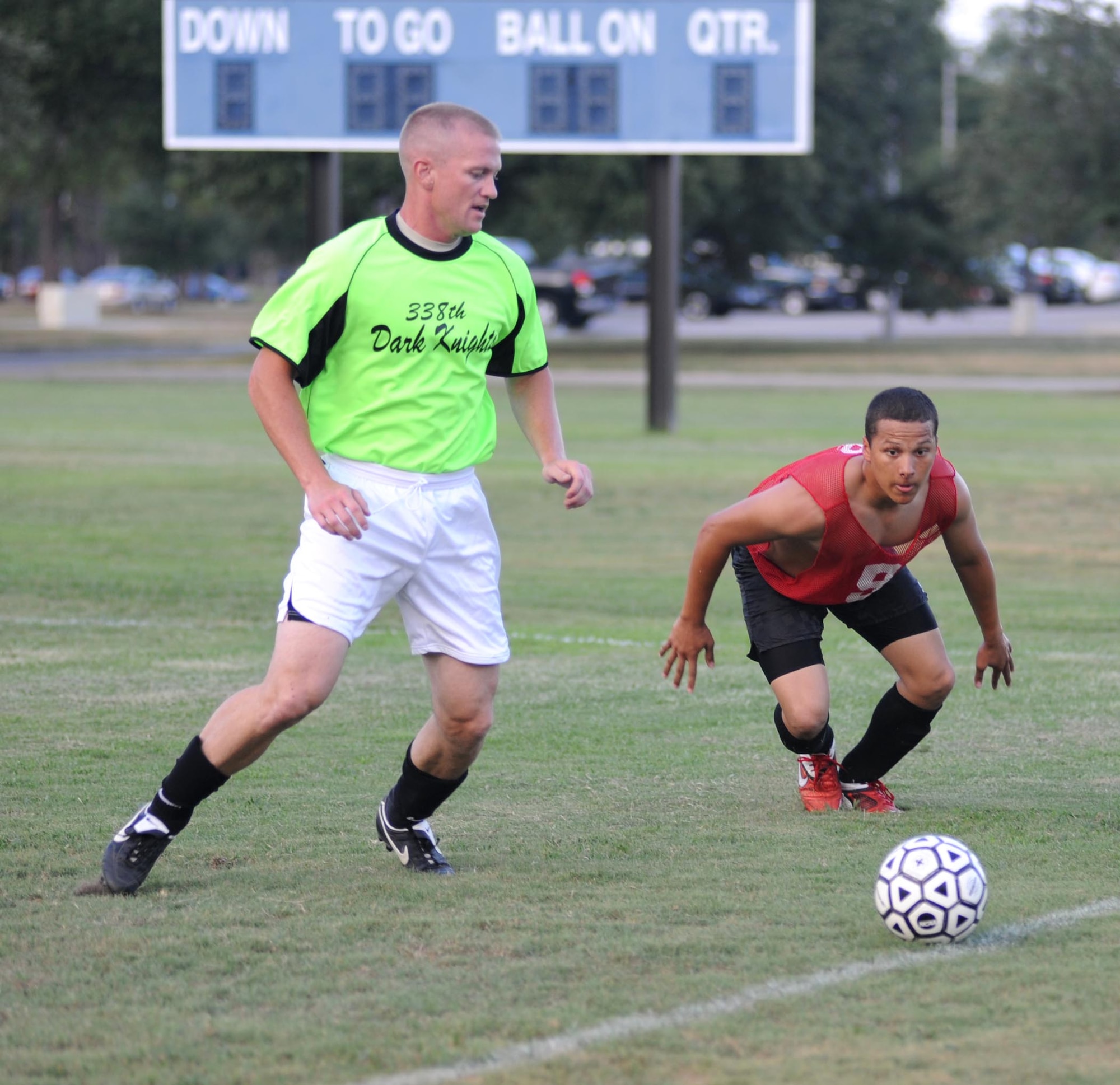 Justin Ross, left, 338th TRS-A, moves in to block Jordan Giswold, 334th TRS-B, during an East Division contest July 14. The 338th TRS Dark Knights defeated the 334th TRS Gators, 2-1. However, the 338th TRS-A team left the East Division to join forces with the squadron’s B-team for the rest of the season.  (U.S. Air Force photo by Kemberly Groue)