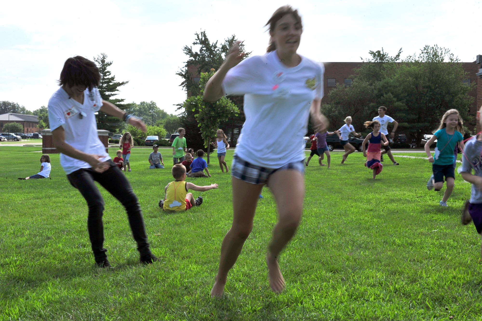 SCOTT AIR FORCE BASE, Ill. -- Children and volunteers play a game on the lawn outside of Chapel 1 during Protestant Vacation Bible School on Scott AFB, Ill July 13. This years’ theme is Big Apple Adventure. (U.S. Air Force photo/ Staff Sgt Stephenie Wade)