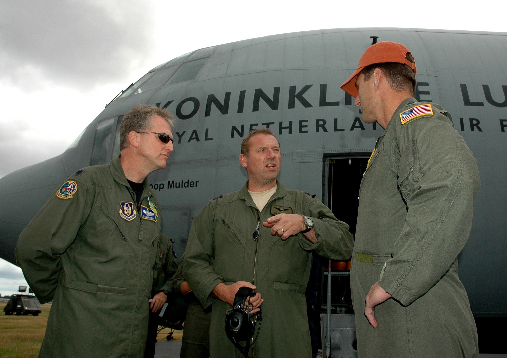 Reservists Lt. Col. "Dutch" Coumou and Lt.. Col. Colin Carr, greet Dutch Majoor Rolph Diebels,Royal Netherlands Air Force, after the team's arrival July 19 at McChord Field, Wash., for Air Mobility Rodeo. Rodeo will be at McChord Field July 24-29, although international teams started arriving July 18.  Coumo and Carr are with the 728th Airlift Squadron here, which is hosting the team from the Netherlands during Rodeo. (U.S. Air Force photo by Sandra Pishner)