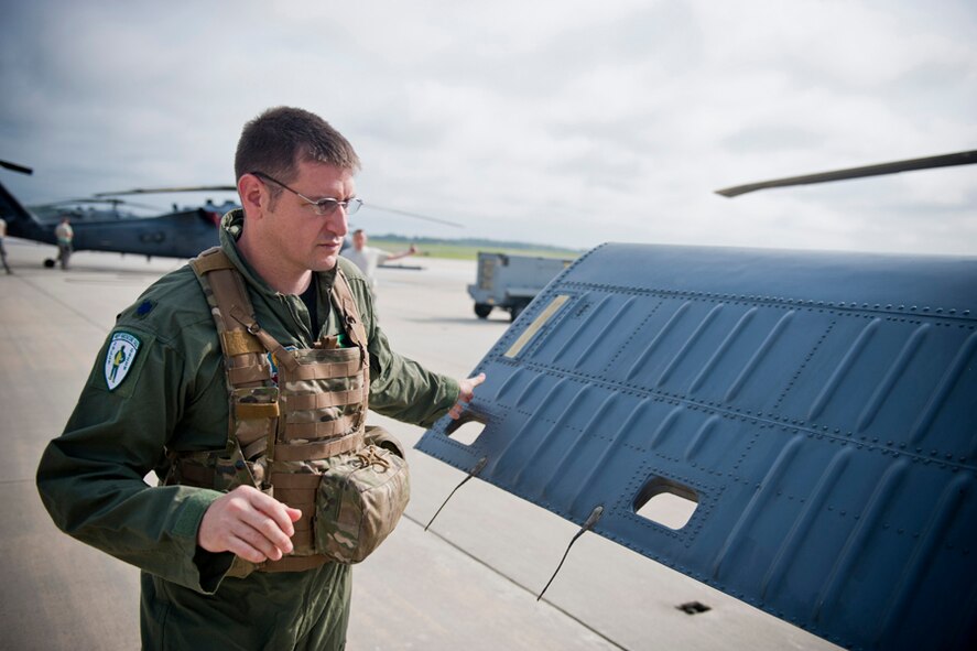 U.S. Air Force Lt. Col. Jeremey Turner, 41st Rescue Squadron commander, conducts a pre-flight inspection on an HH-60G Pave Hawk in preparation for a training mission at Moody Air Force Base, Ga., July 12, 2011. During the inspection, Turner checked for anything out of the ordinary that would present a safety hazard. (U.S. Air Force photo by Staff Sgt. Jamal D. Sutter/Released)