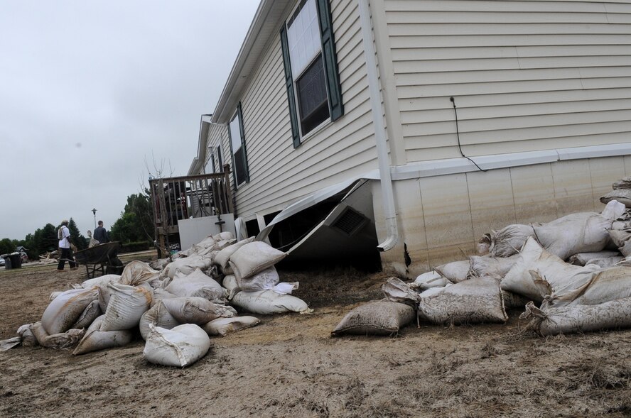 MINOT AIR FORCE BASE, N.D. -- The house here owned by Tech. Sgt. Lance Berentson, 741st Missile Squadron facility manager, was one of the thousands of homes affected by the recent historic flooding situation in Minot. When Berentson and his family were allowed back into their home they noticed their basement was flooded, their house’s foundation damaged and their yard in shambles. (U.S. Air Force photo/Airman 1st Class Jose L. Hernandez)