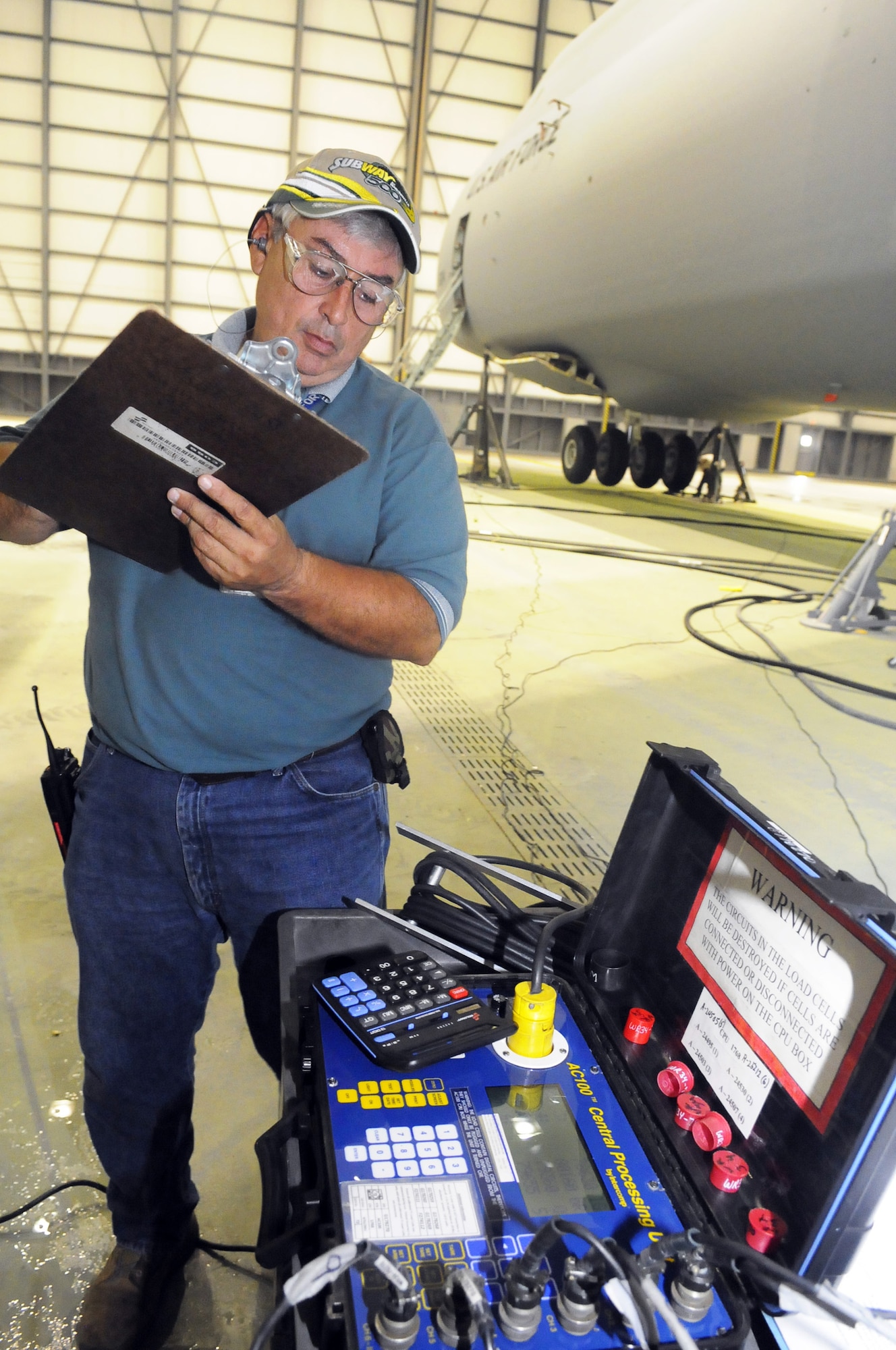 Allen Tillit records the weight of the C-5. U. S. Air Force photo by Sue Sapp
