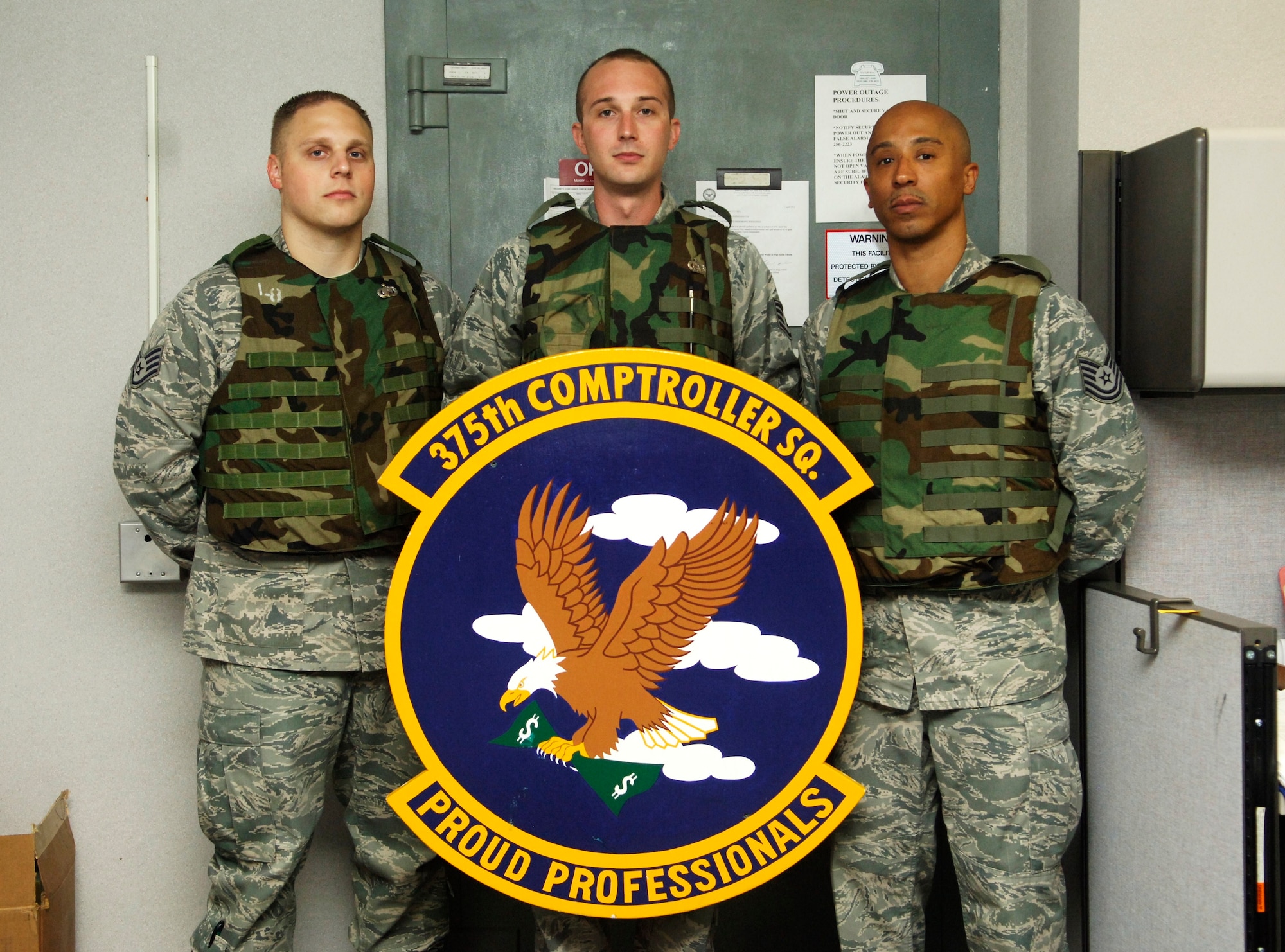 From left, 375th Comptroller Squadron members Staff Sgt. Justin Ellrich, Staff Sgt. Robert Shearer and Tech. Sgt. Kurt Wells pose for a picture July 18 in front of the 375th CPTS vault. Ellrich, Shearer and Wells will represent Team Scott in the finance management portion of the 2011 Air Mobility Rodeo at McChord Field, Joint Base Lewis-McChord, Wash., July 24–29.(U.S. Air Force photo/ Samantha Crane)