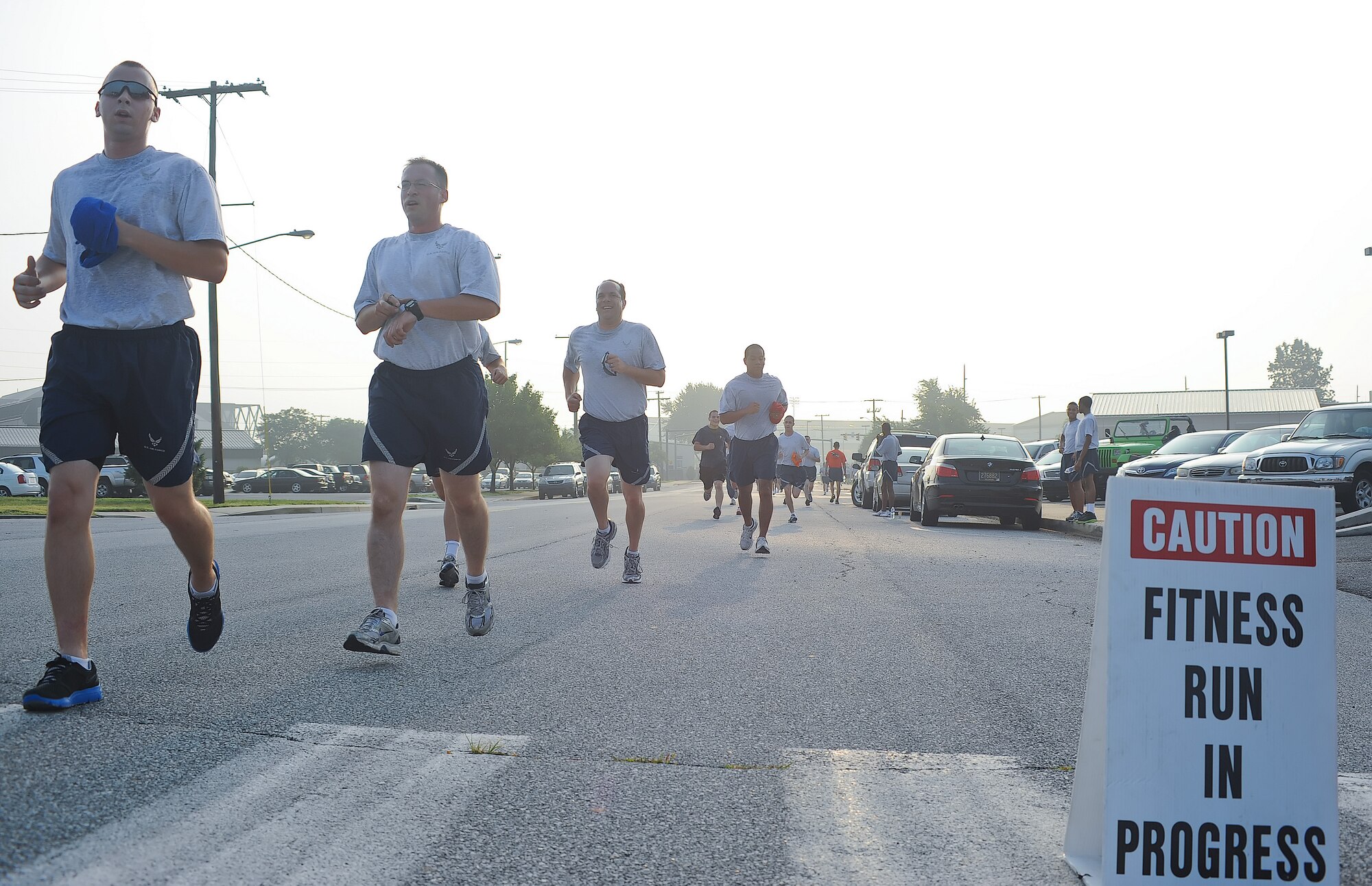 Airmen cross the finish line during the Warrior Run July 20, 2011, at Dover Air Force Base, Del. Dozens of Airmen participated in the five-kilometer run, which are held monthly to build morale and emphasize fitness.  (U.S. Air Force photo by Airman 1st Class Samuel Taylor)