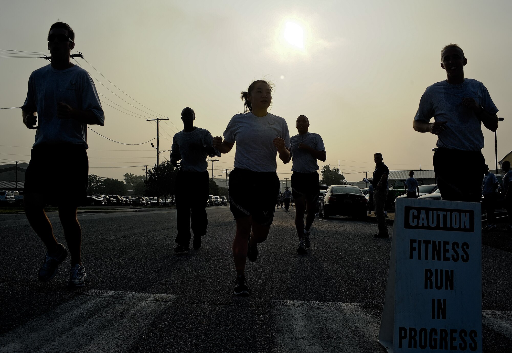 Airmen cross the finish line during the Warrior Run July 20, 2011, at Dover Air Force Base, Del. Dozens of Airmen participated in the five-kilometer run, which are held monthly to build morale and emphasize fitness.  (U.S. Air Force photo by Airman 1st Class Samuel Taylor)