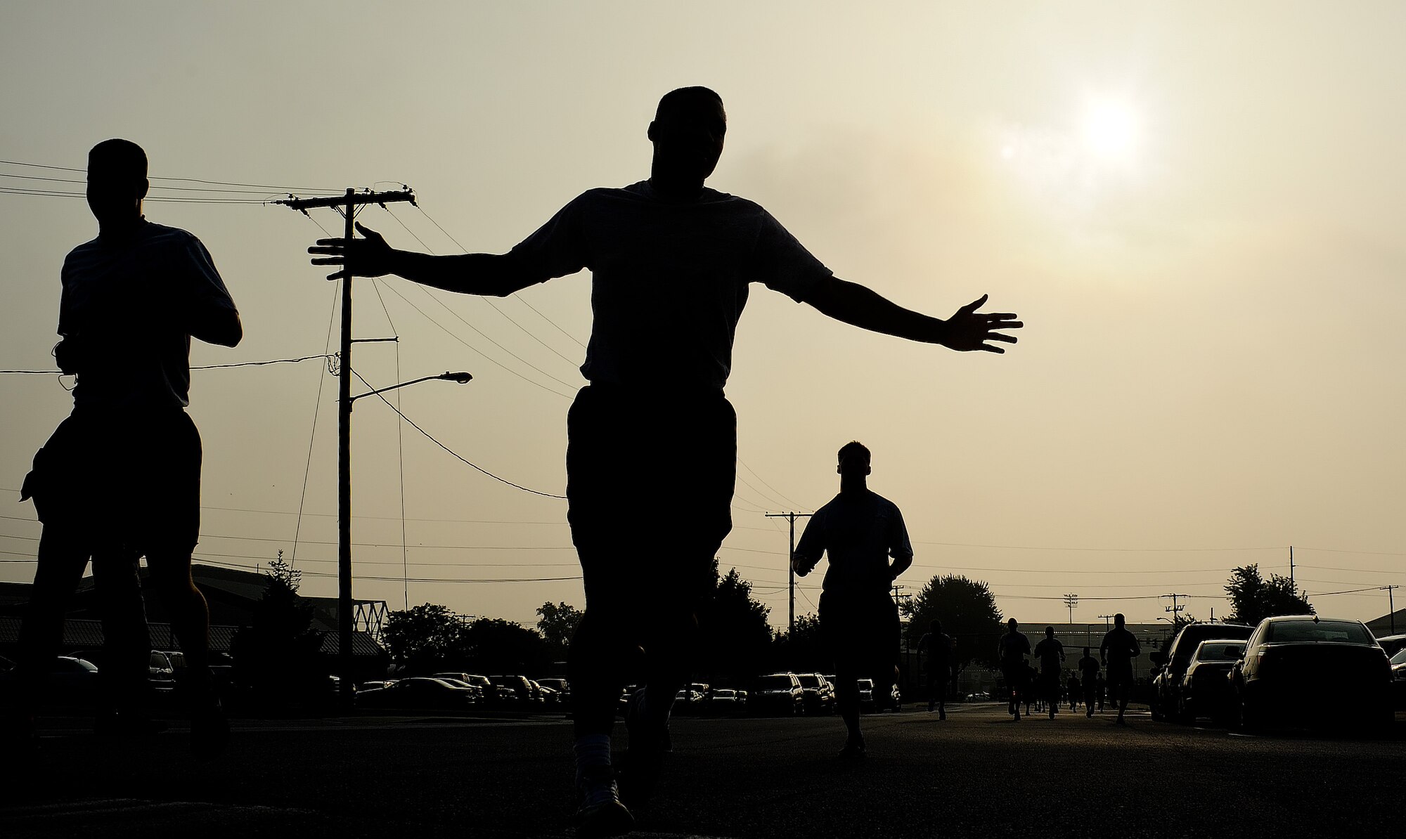 Airmen cross the finish line during the Warrior Run July 20, 2011, at Dover Air Force Base, Del. Dozens of Airmen participated in the five-kilometer run, which are held monthly to build morale and emphasize fitness.  (U.S. Air Force photo by Airman 1st Class Samuel Taylor)