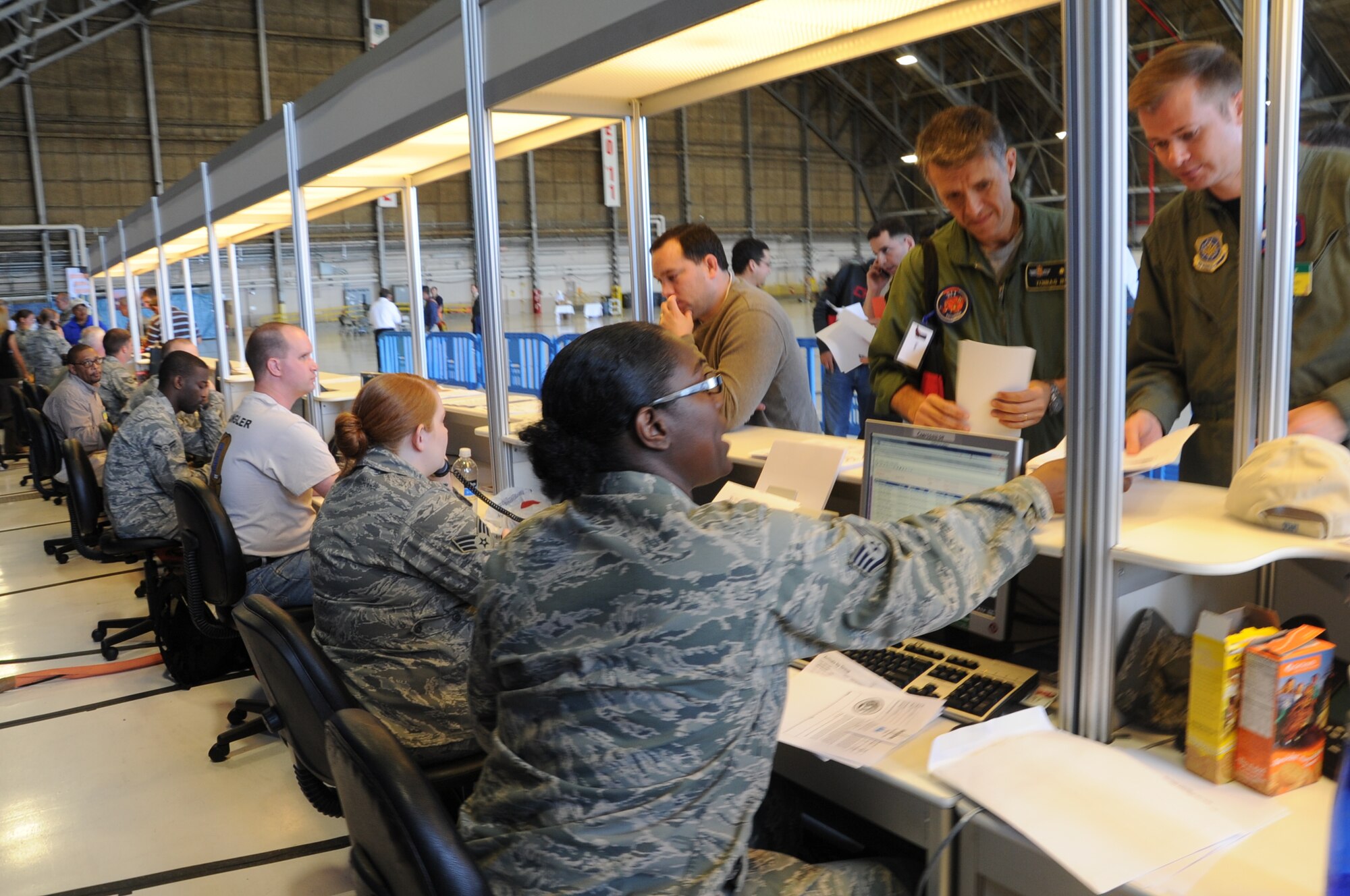 Airmen process through the processing line for Air Mobility Rodeo 2011 at Joint Base Lewis-McChord, Wash., on July 18, 2011. Rodeo is the U.S. Air Force's and Air Mobility Command's premier international combat skills and flying operations competition designed to develop and improve techniques, procedures, and interoperability, while optimizing international mobility  partnerships and enhancing mobility operations. (U.S. Air Force Photo/Tech. Sgt. Christine Jones)